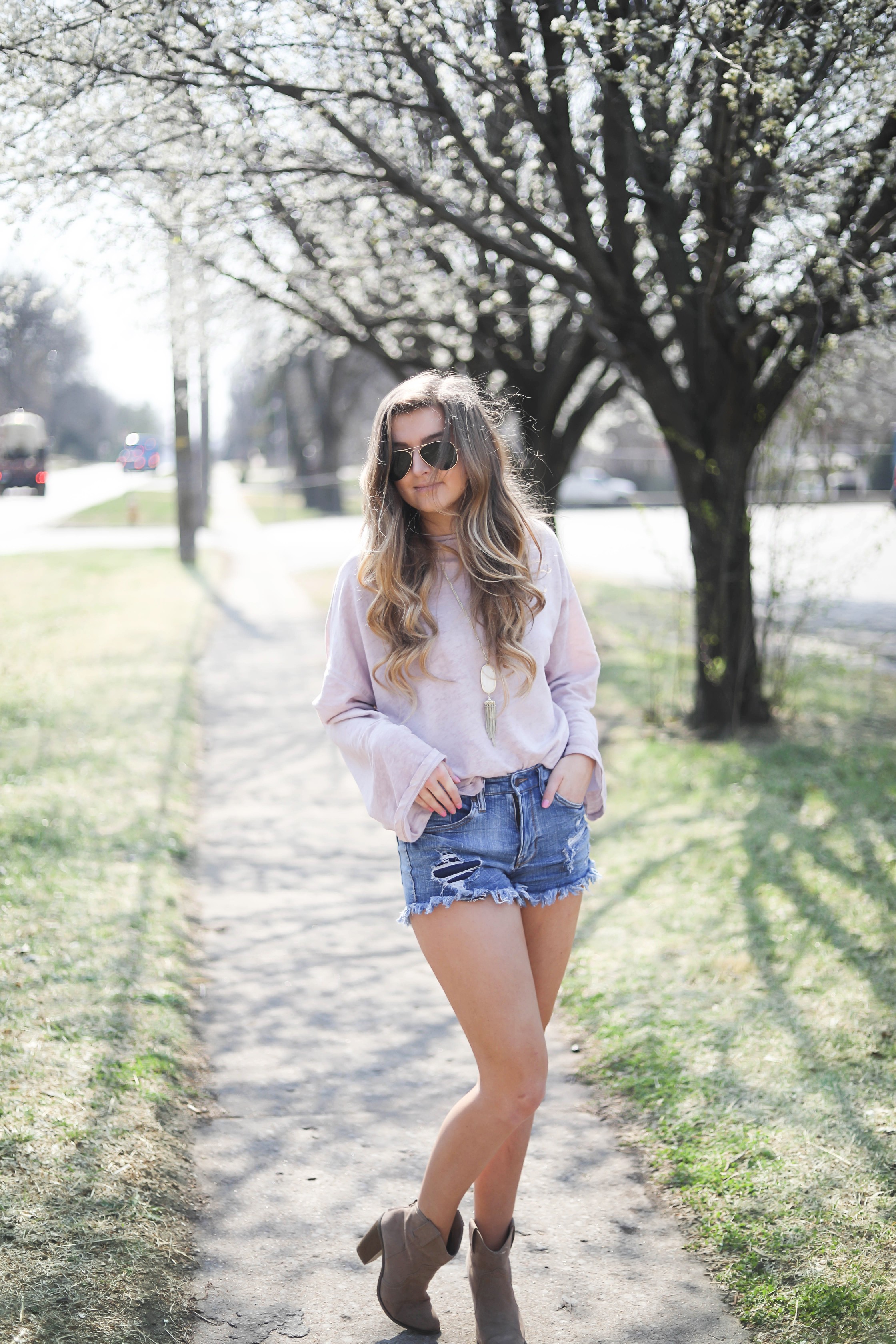 Spring outfit! You can tell it's officially spring when the trees start to bloom! I love this cozy pink top with ripped jeans. I paired them with my favorite booties and white kendra Scott necklace! By Lauren Lindmark dailydoseofcharm.com daily dose of charm