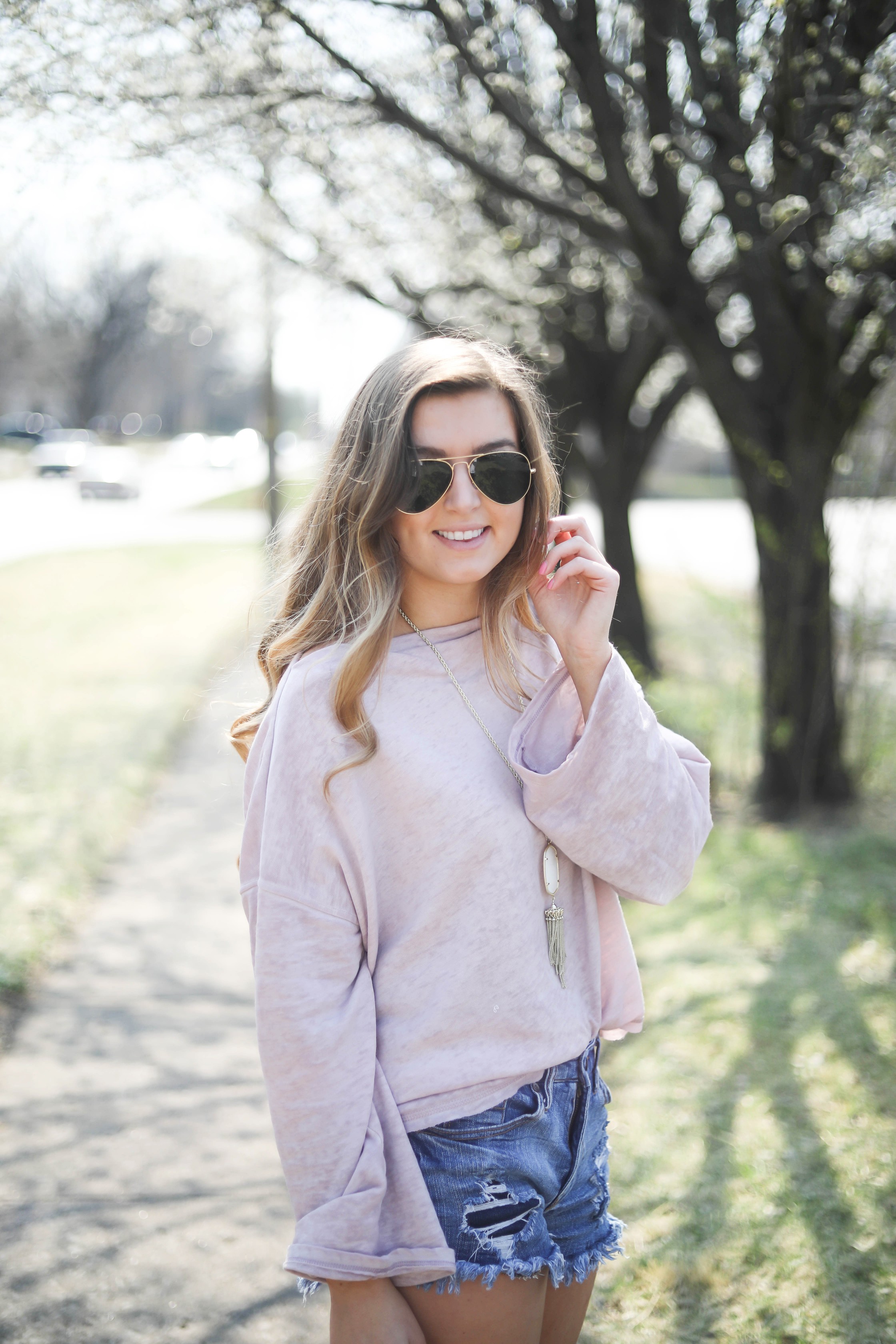 Spring outfit! You can tell it's officially spring when the trees start to bloom! I love this cozy pink top with ripped jeans. I paired them with my favorite booties and white kendra Scott necklace! By Lauren Lindmark dailydoseofcharm.com daily dose of charm