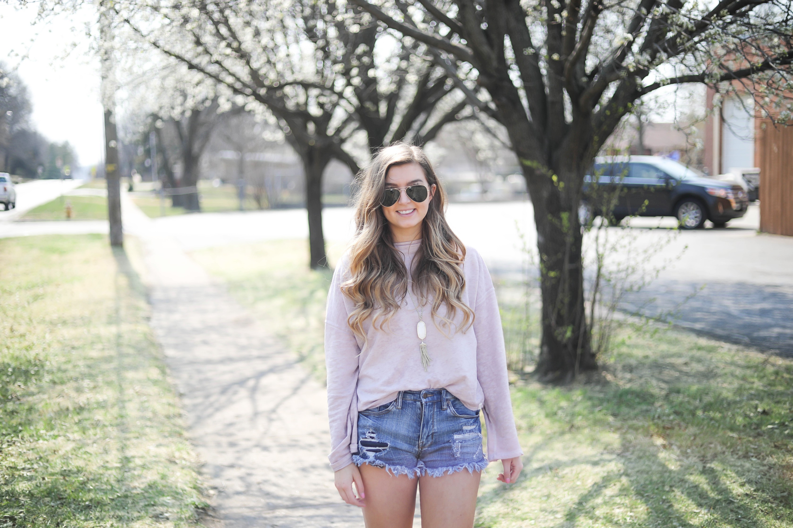 Spring outfit! You can tell it's officially spring when the trees start to bloom! I love this cozy pink top with ripped jeans. I paired them with my favorite booties and white kendra Scott necklace! By Lauren Lindmark dailydoseofcharm.com daily dose of charm