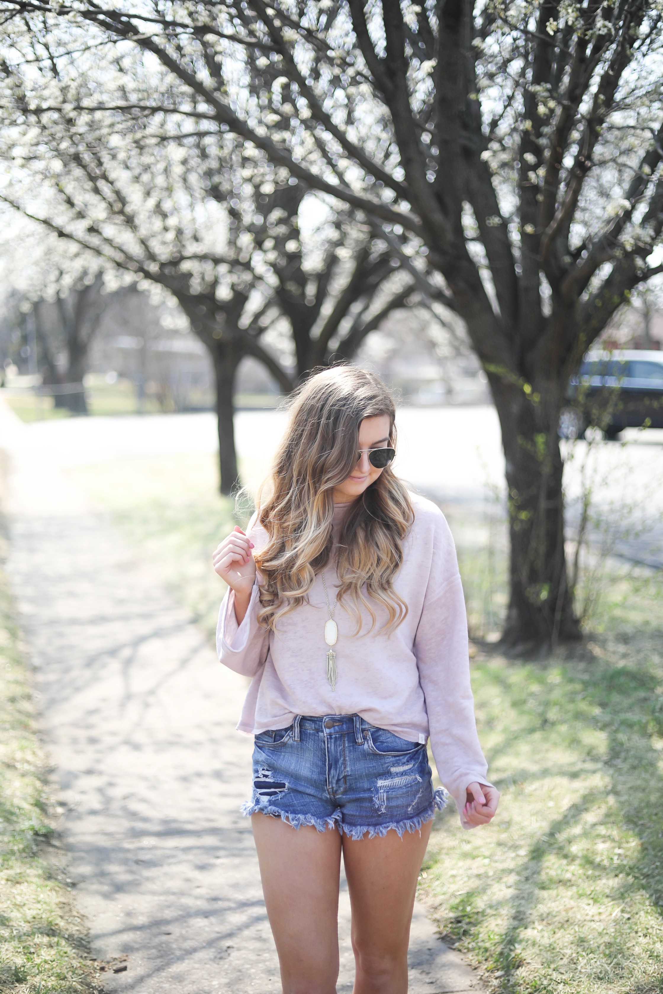 Spring outfit! You can tell it's officially spring when the trees start to bloom! I love this cozy pink top with ripped jeans. I paired them with my favorite booties and white kendra Scott necklace! By Lauren Lindmark dailydoseofcharm.com daily dose of charm