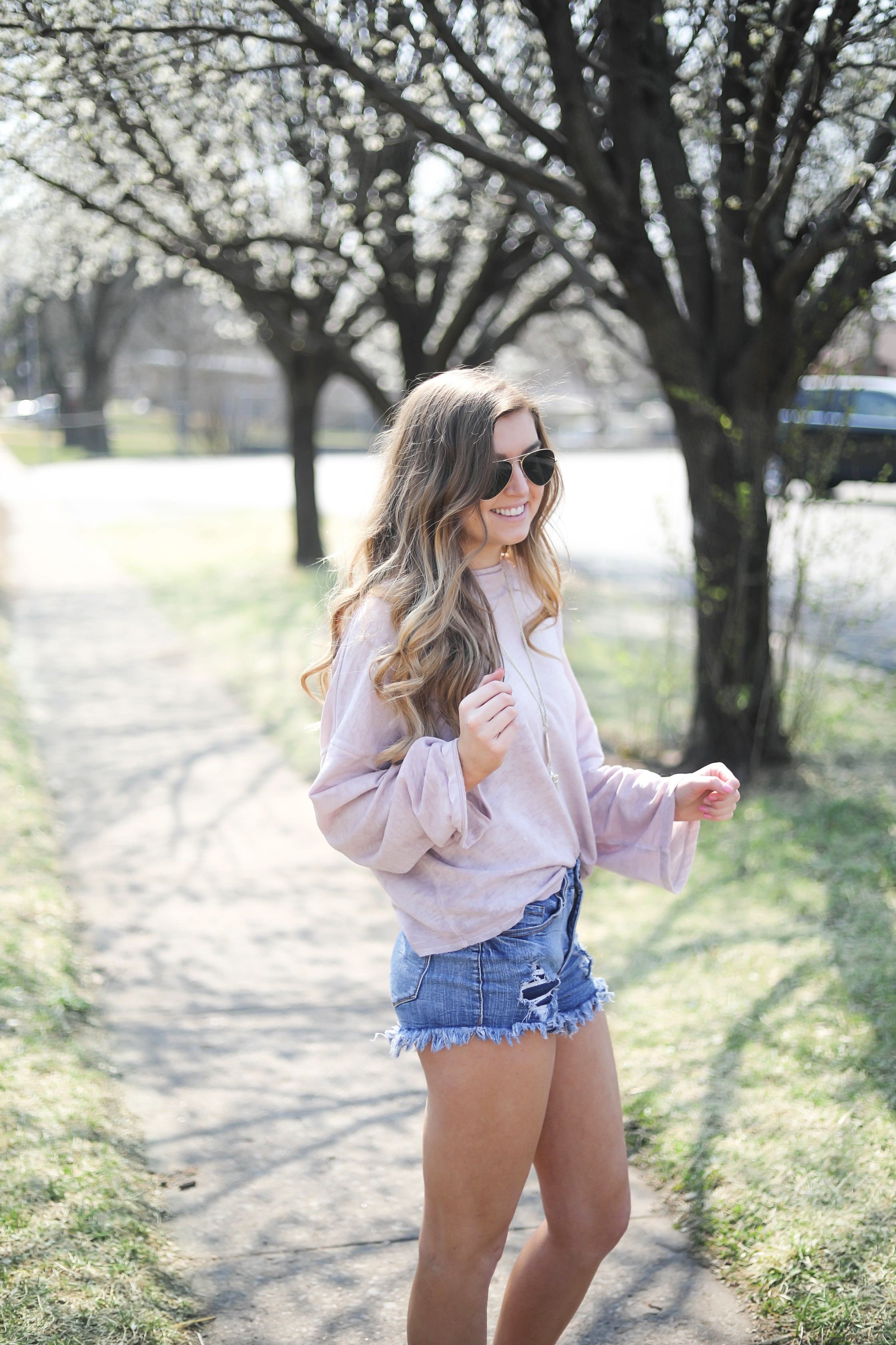 Spring outfit! You can tell it's officially spring when the trees start to bloom! I love this cozy pink top with ripped jeans. I paired them with my favorite booties and white kendra Scott necklace! By Lauren Lindmark dailydoseofcharm.com daily dose of charm