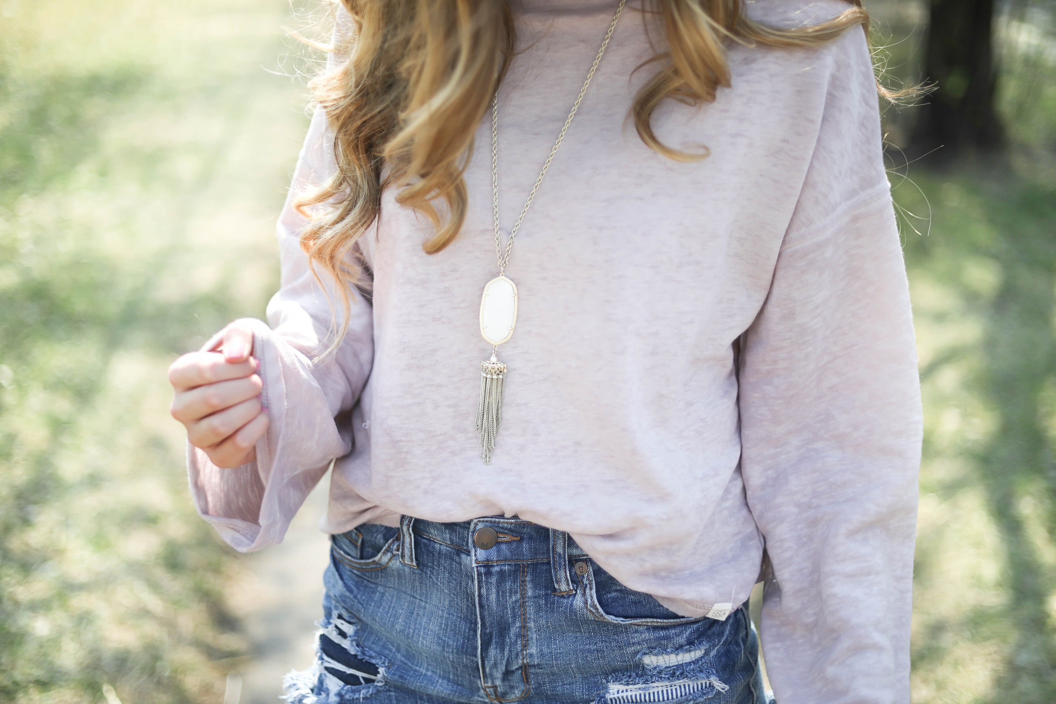 Spring outfit! You can tell it's officially spring when the trees start to bloom! I love this cozy pink top with ripped jeans. I paired them with my favorite booties and white kendra Scott necklace! By Lauren Lindmark dailydoseofcharm.com daily dose of charm