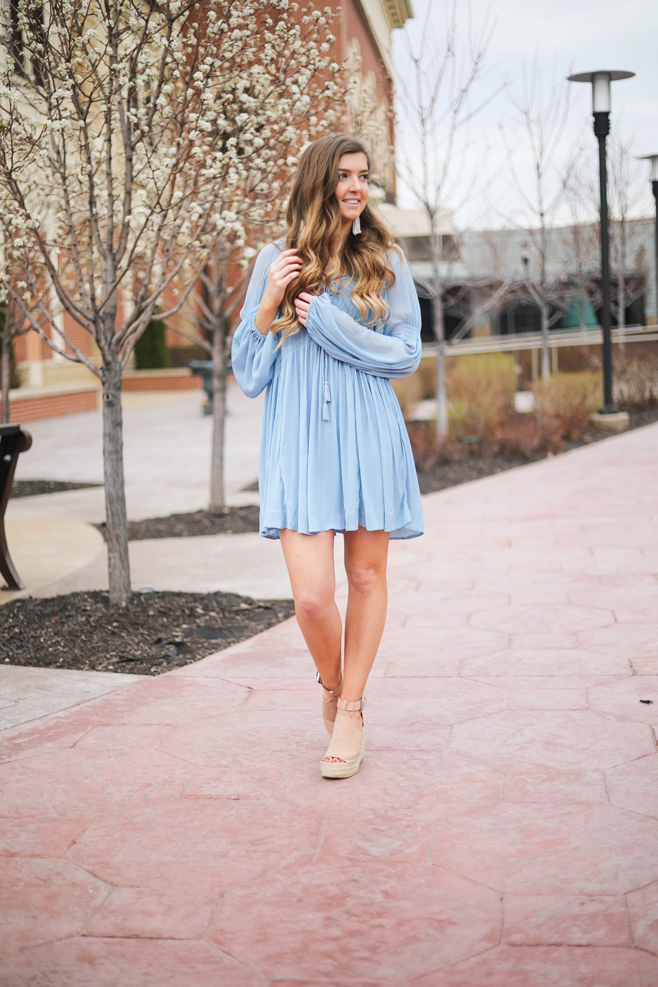 The prettiest flowy light blue dress up on the blog! Paired with Marc Fisher wedges and Lisi Lerch white tassel earrings. Details and links are all on the blog dailydoseofcharm.com daily dose of charm lauren Lindmark