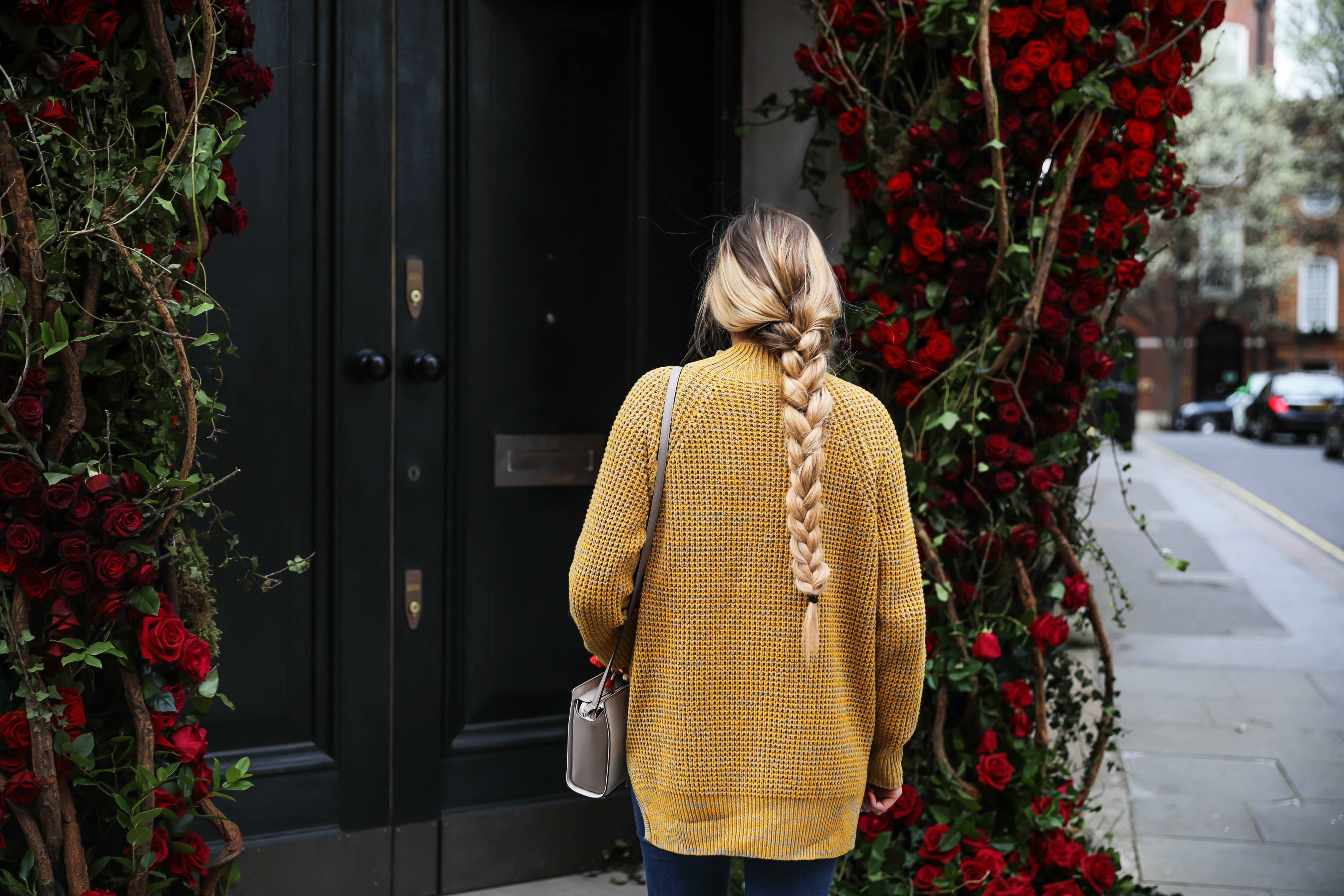 The cutest yellow sweater up on the blog! These photos were taken in front of the most beautiful roses in London! Cute London outfit! By Lauren Lindmark on dailydoseofcharm.com daily dose of charm