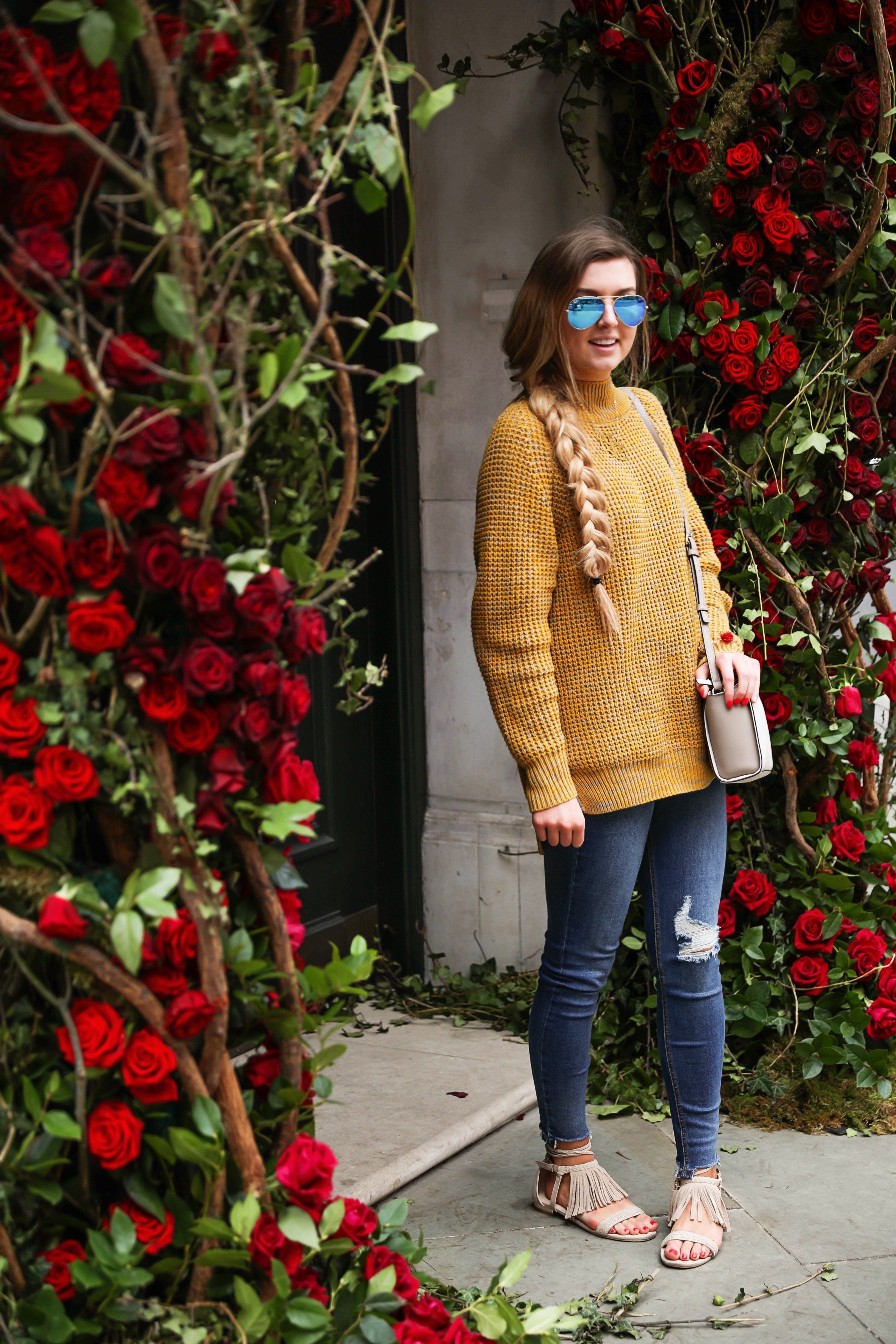 The cutest yellow sweater up on the blog! These photos were taken in front of the most beautiful roses in London! Cute London outfit! By Lauren Lindmark on dailydoseofcharm.com daily dose of charm