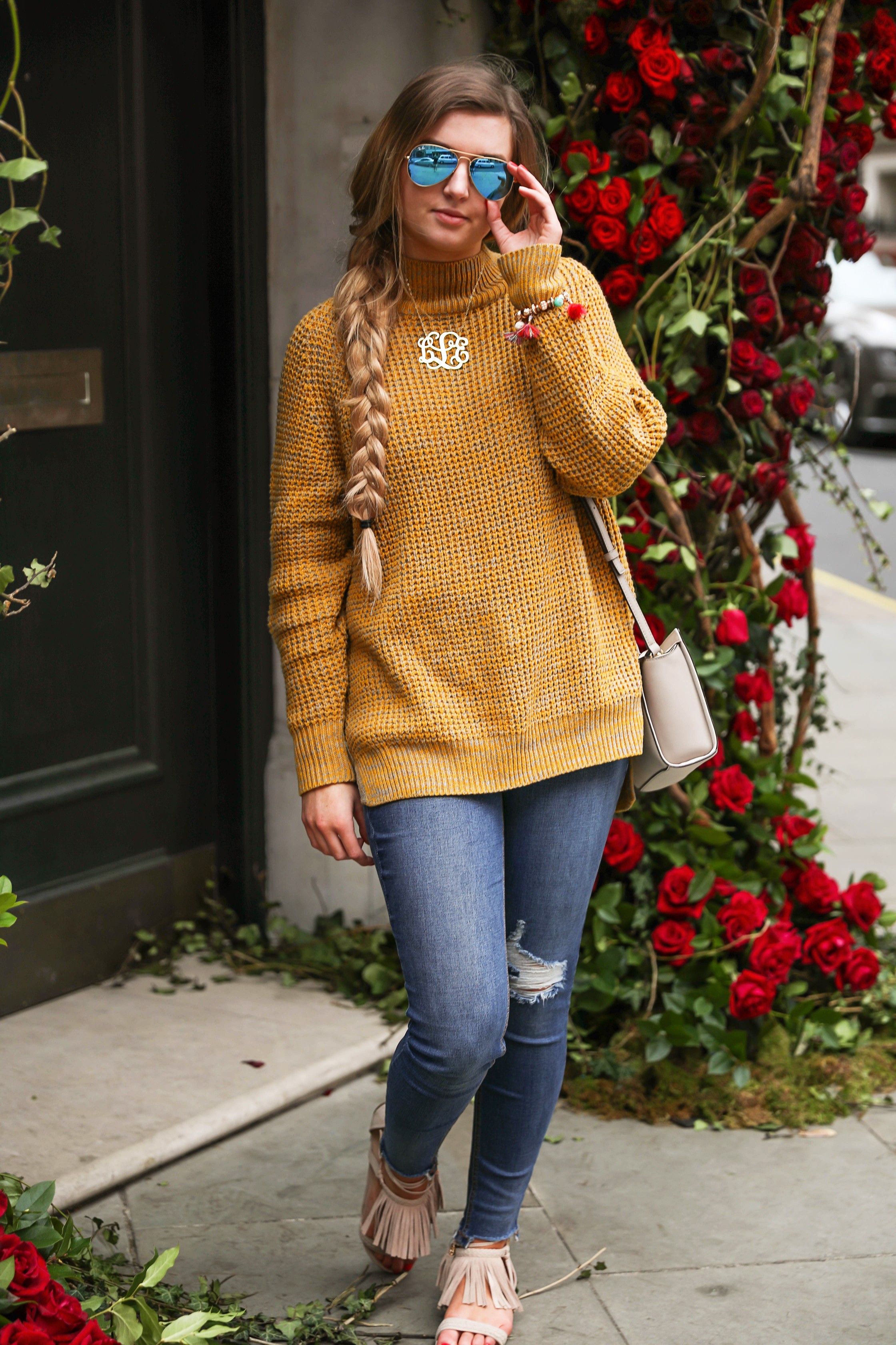 The cutest yellow sweater up on the blog! These photos were taken in front of the most beautiful roses in London! Cute London outfit! By Lauren Lindmark on dailydoseofcharm.com daily dose of charm