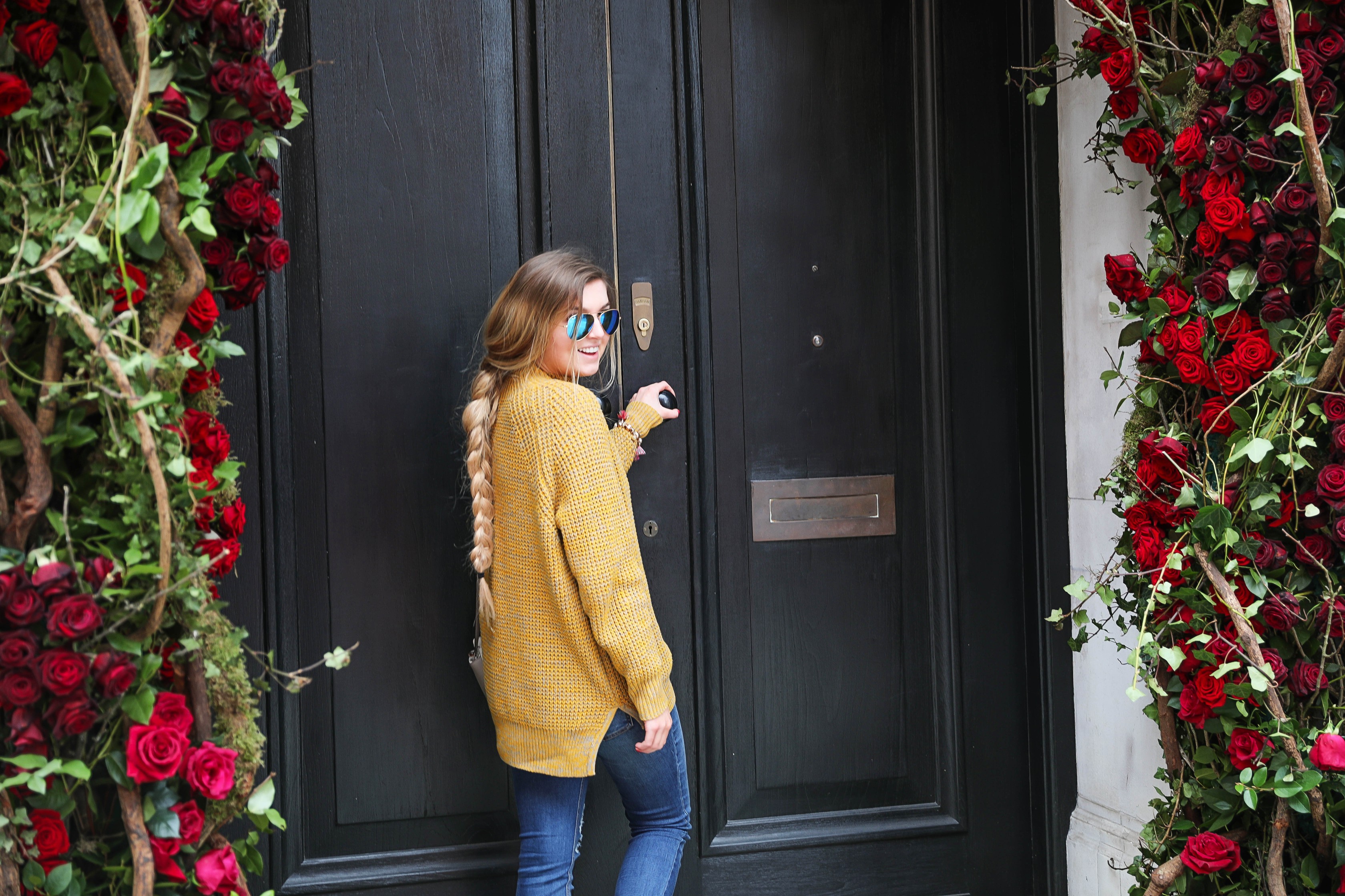 The cutest yellow sweater up on the blog! These photos were taken in front of the most beautiful roses in London! Cute London outfit! By Lauren Lindmark on dailydoseofcharm.com daily dose of charm
