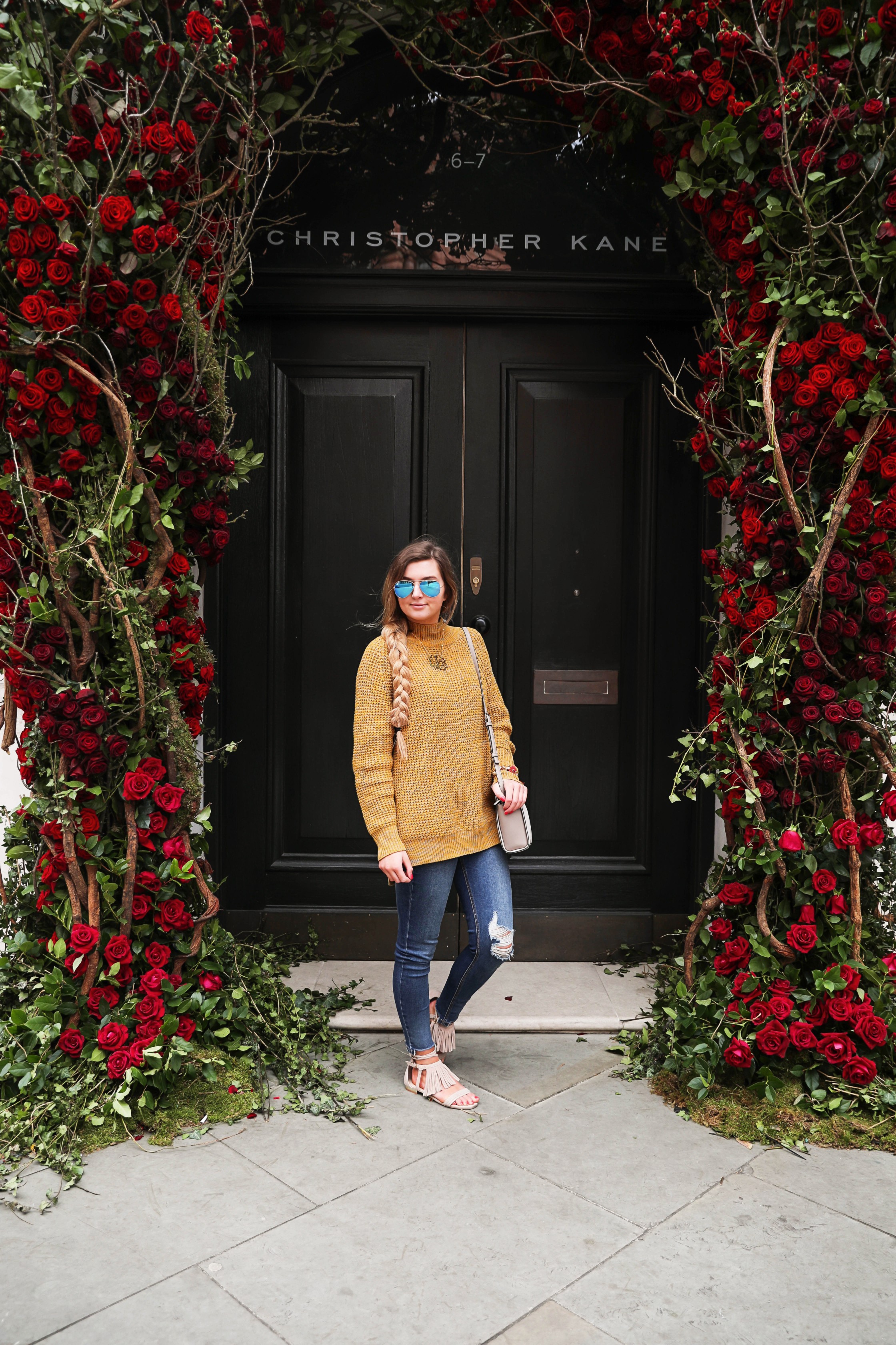 The cutest yellow sweater up on the blog! These photos were taken in front of the most beautiful roses in London! Cute London outfit! By Lauren Lindmark on dailydoseofcharm.com daily dose of charm