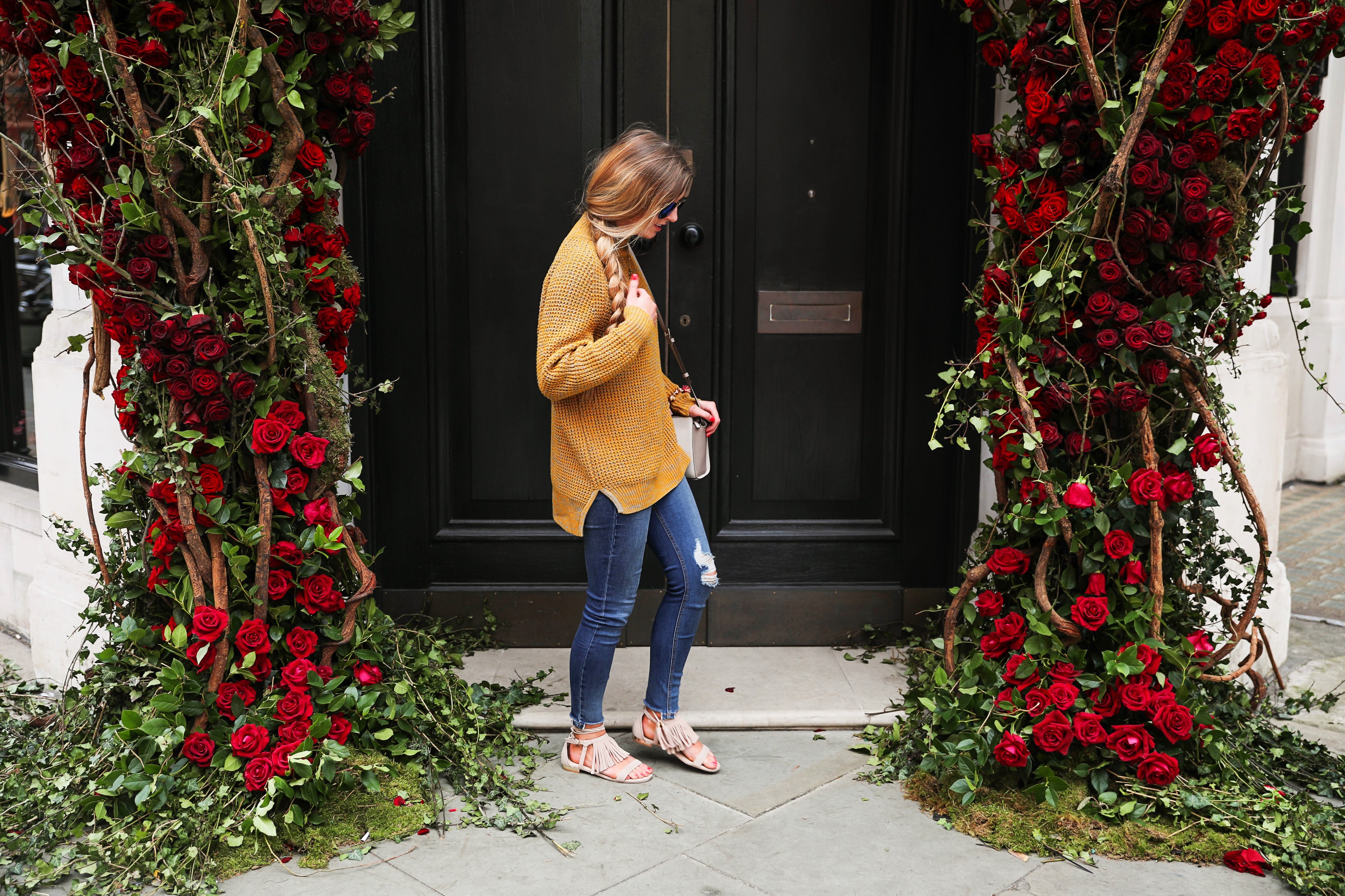 The cutest yellow sweater up on the blog! These photos were taken in front of the most beautiful roses in London! Cute London outfit! By Lauren Lindmark on dailydoseofcharm.com daily dose of charm