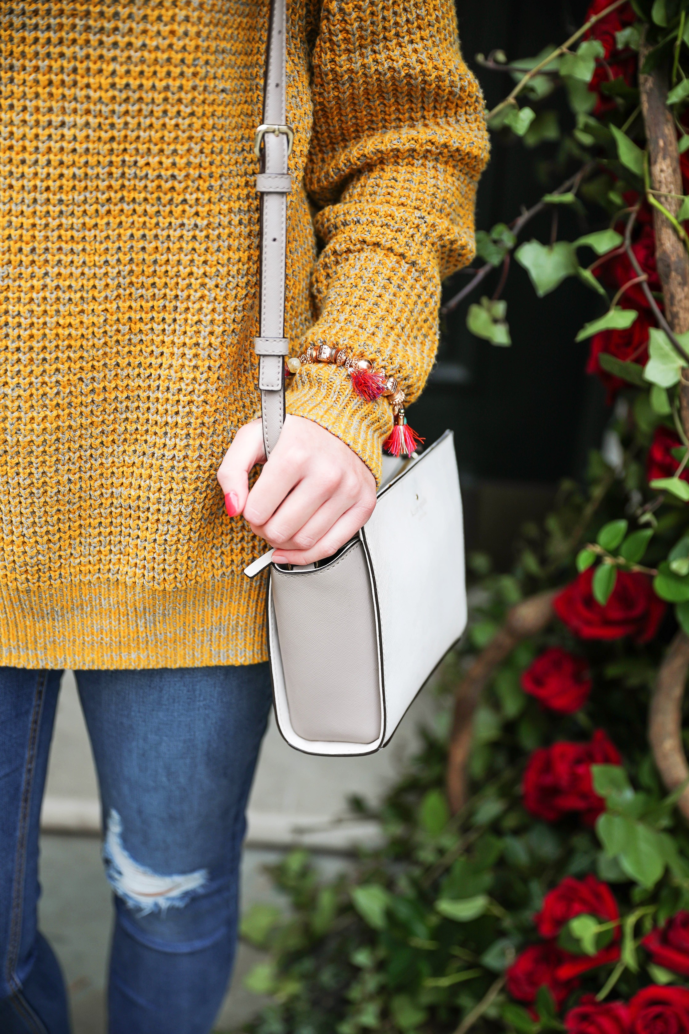 The cutest yellow sweater up on the blog! These photos were taken in front of the most beautiful roses in London! Cute London outfit! By Lauren Lindmark on dailydoseofcharm.com daily dose of charm