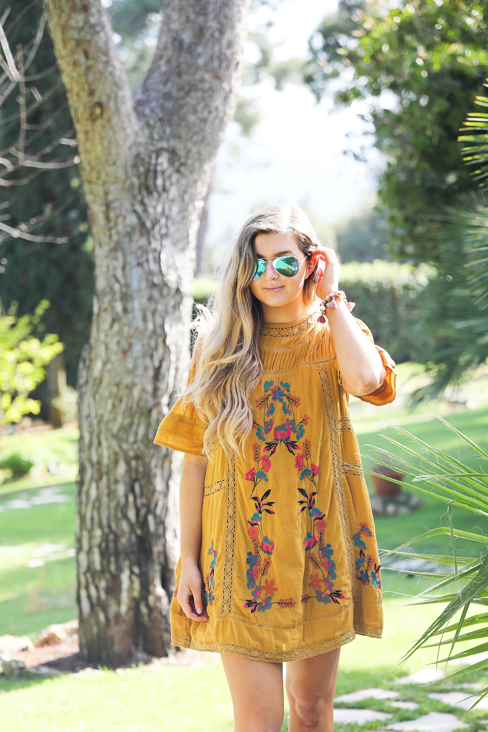 The cutest free people yellow dress! Perfect tropical dress and look so good with my blue mirrored sunglasses! I paired them with my rose Marc Fisher sandals. Full details on the blog dailydoseofcharm.com by lauren Lindmark daily dose of charm