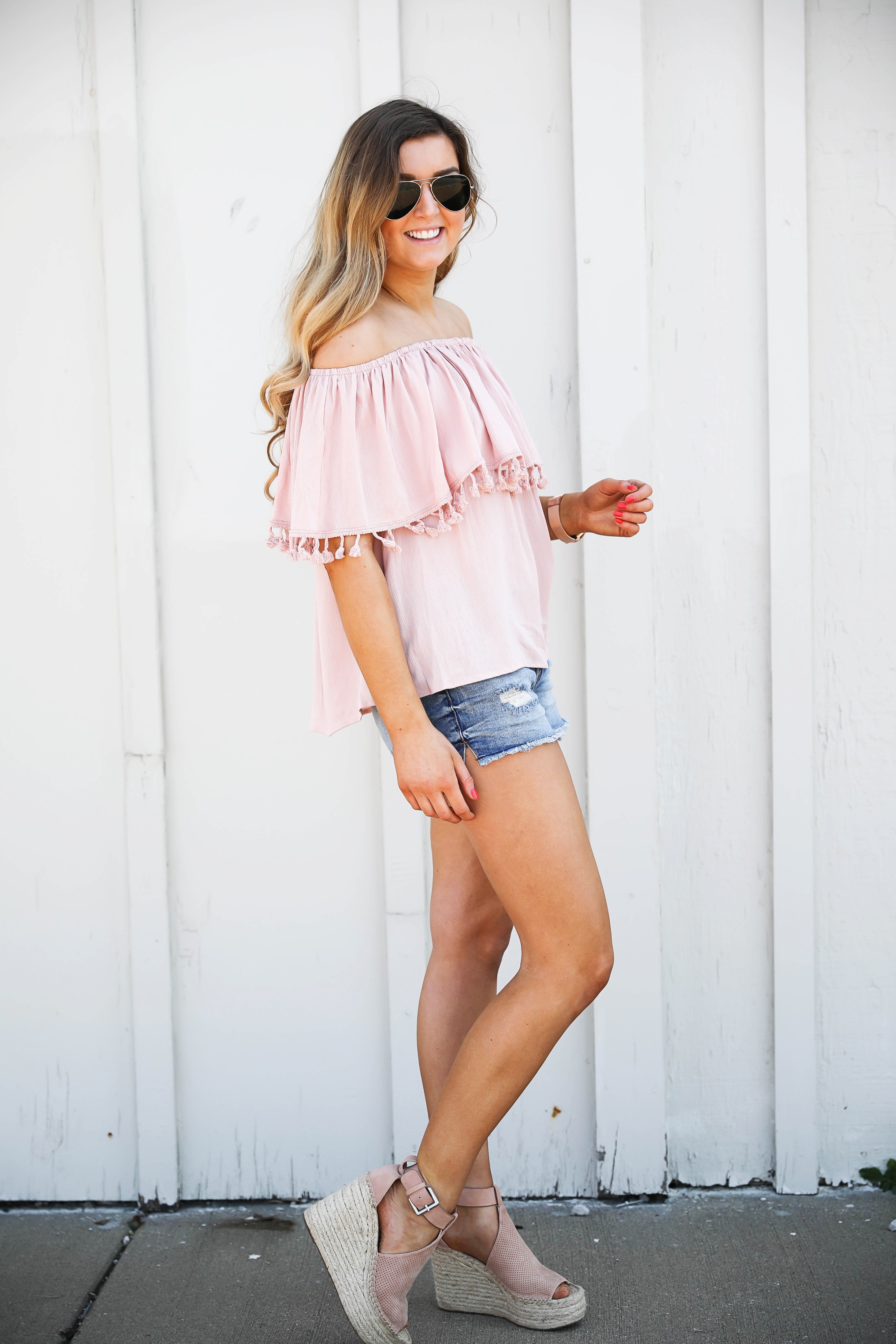 Pink ruffle pom pom top with jean shorts. This is the cutest spring outfit ever! I love the ruffle trend! on Daily Dose of Charm by Lauren Lindmark dailydoseofcharm.com