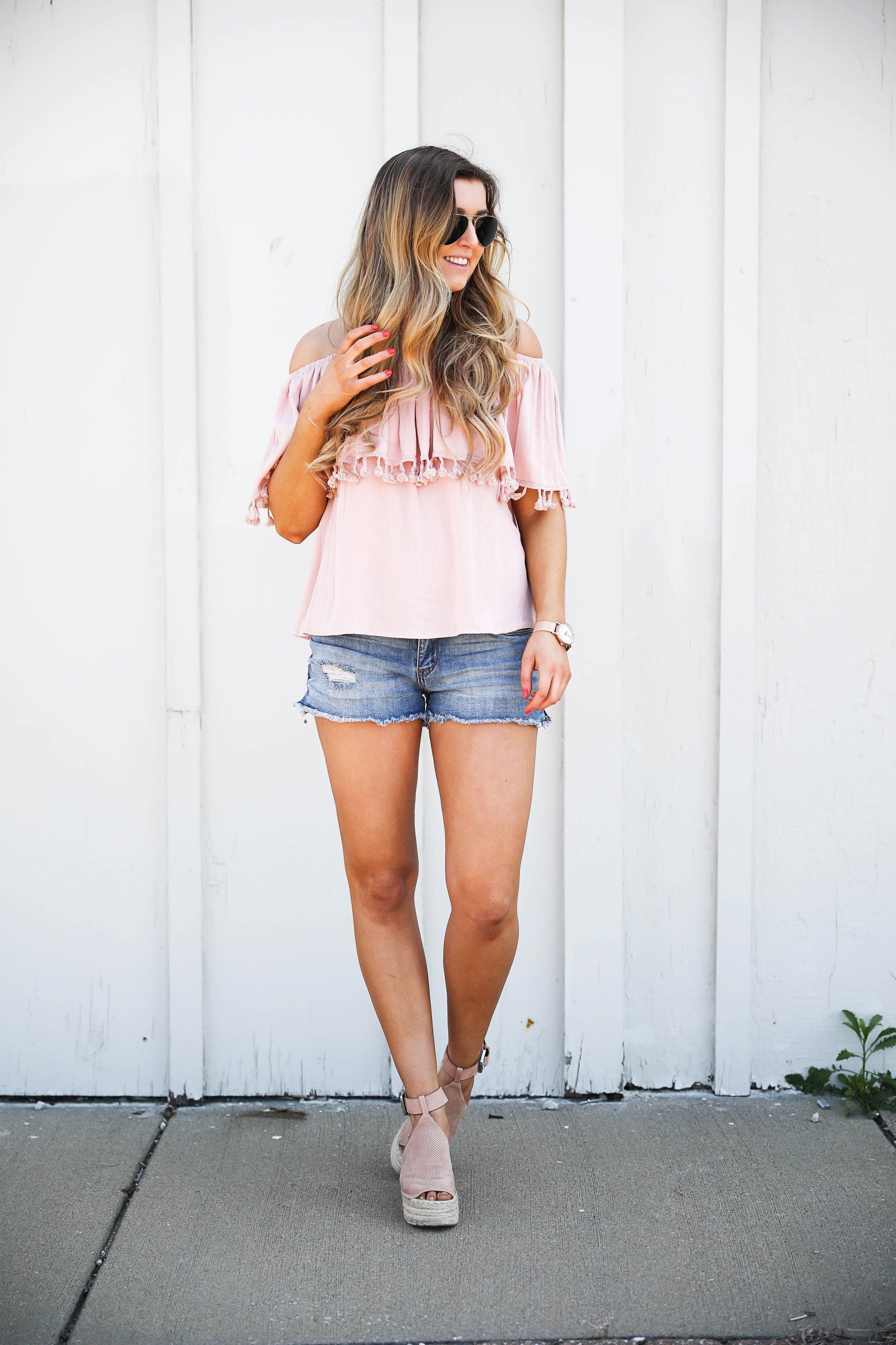 Pink ruffle pom pom top with jean shorts. This is the cutest spring outfit ever! I love the ruffle trend! on Daily Dose of Charm by Lauren Lindmark dailydoseofcharm.com