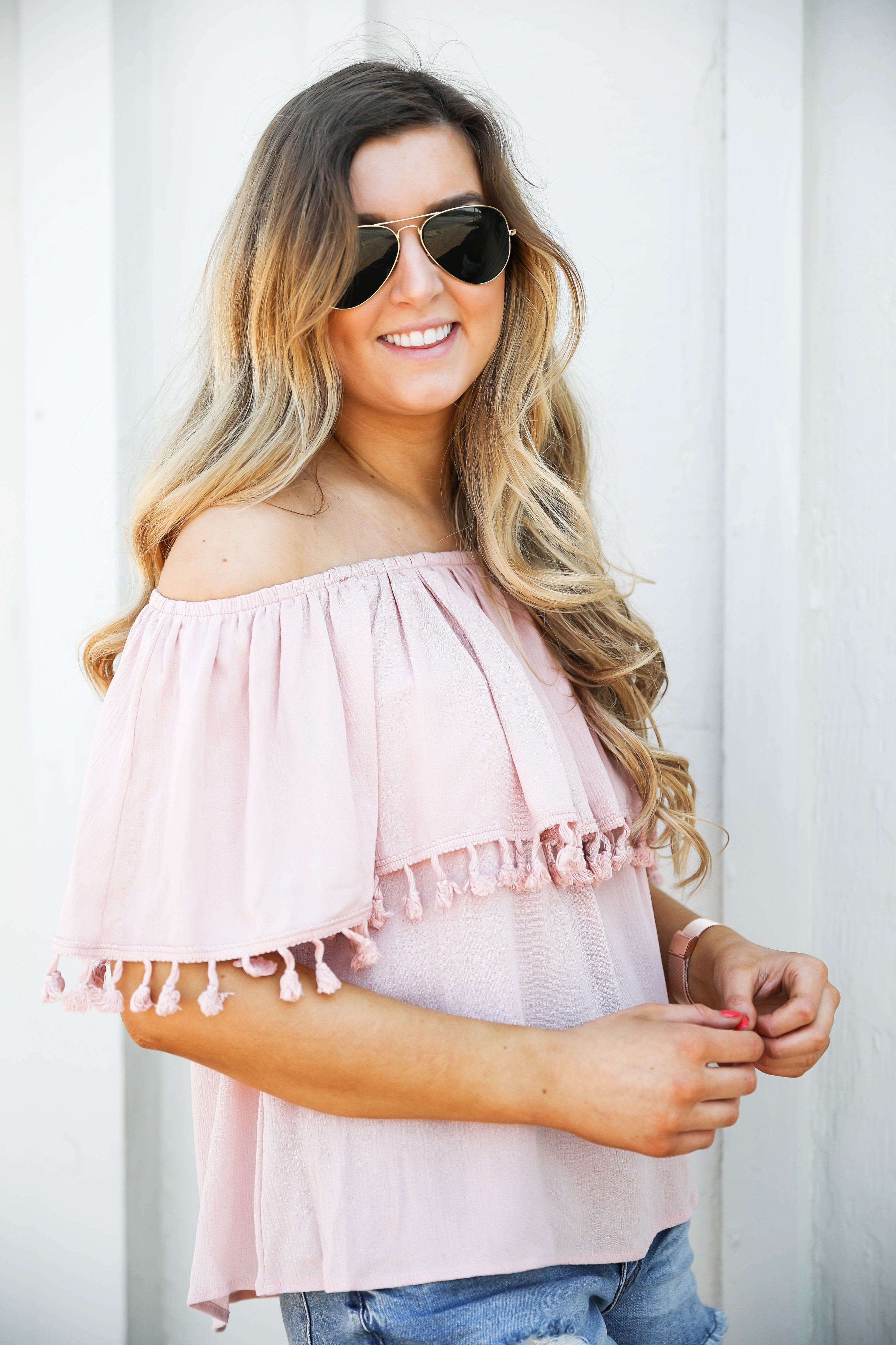 Pink ruffle pom pom top with jean shorts. This is the cutest spring outfit ever! I love the ruffle trend! on Daily Dose of Charm by Lauren Lindmark dailydoseofcharm.com
