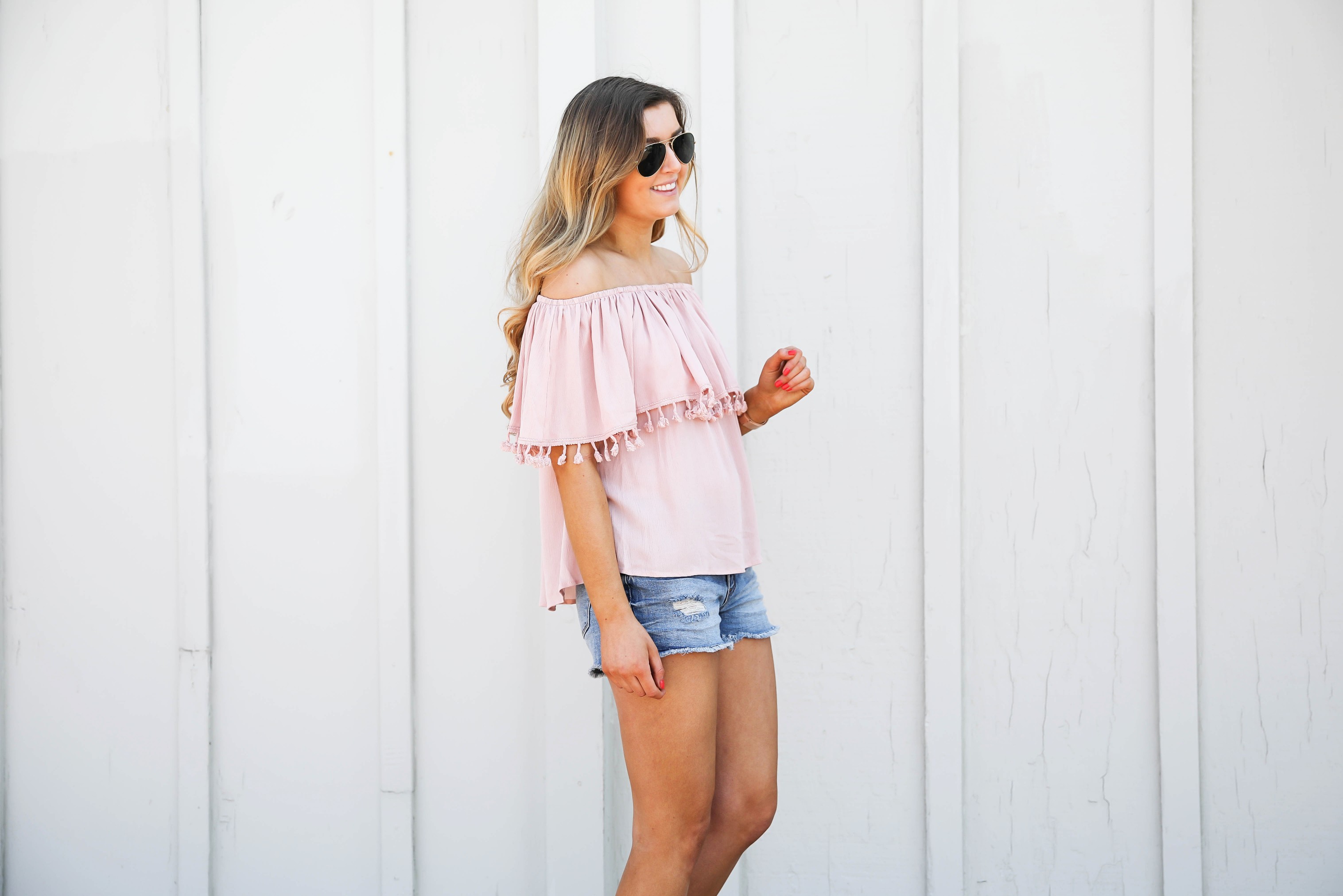 Pink ruffle pom pom top with jean shorts. This is the cutest spring outfit ever! I love the ruffle trend! on Daily Dose of Charm by Lauren Lindmark dailydoseofcharm.com