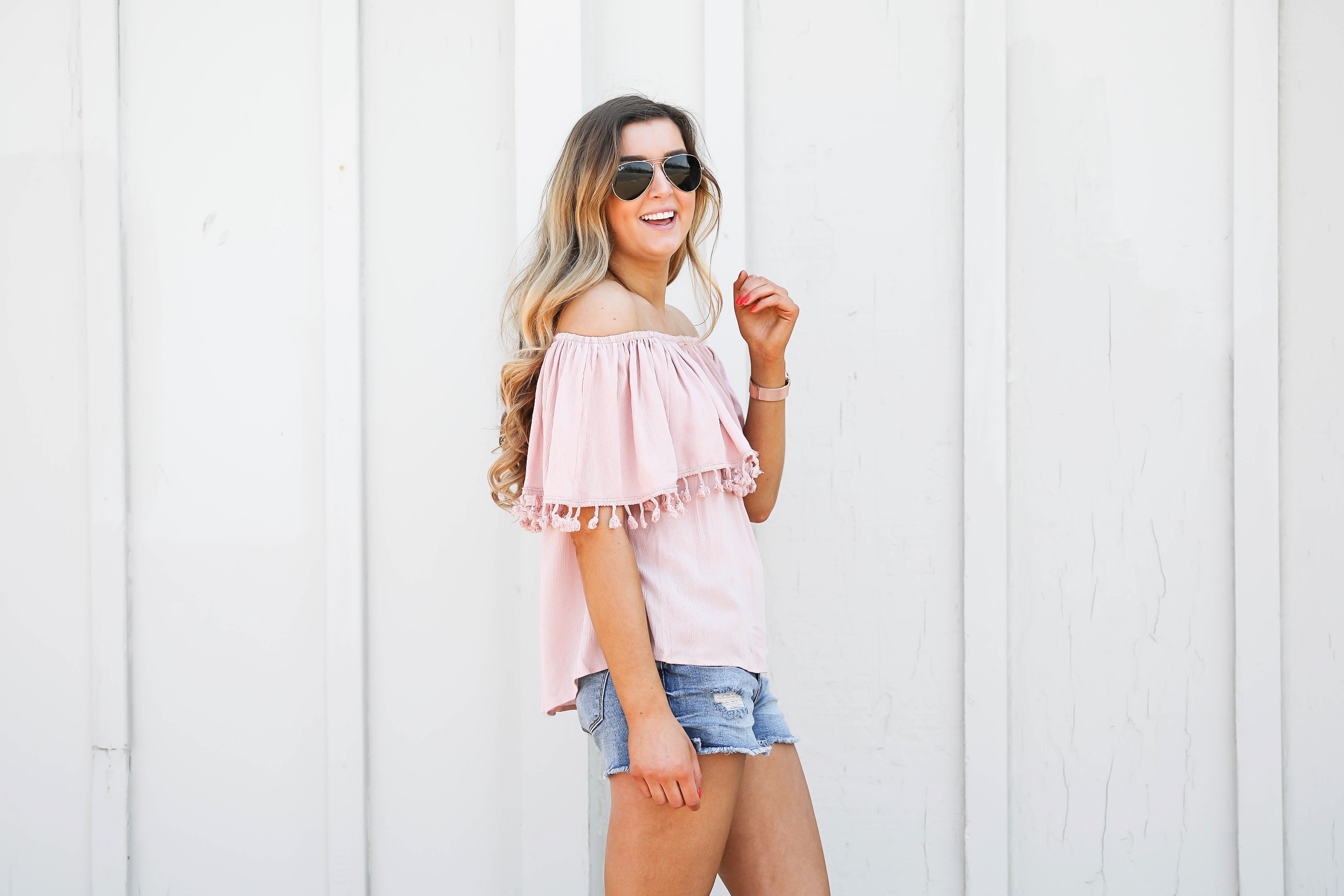 Pink ruffle pom pom top with jean shorts. This is the cutest spring outfit ever! I love the ruffle trend! on Daily Dose of Charm by Lauren Lindmark dailydoseofcharm.com