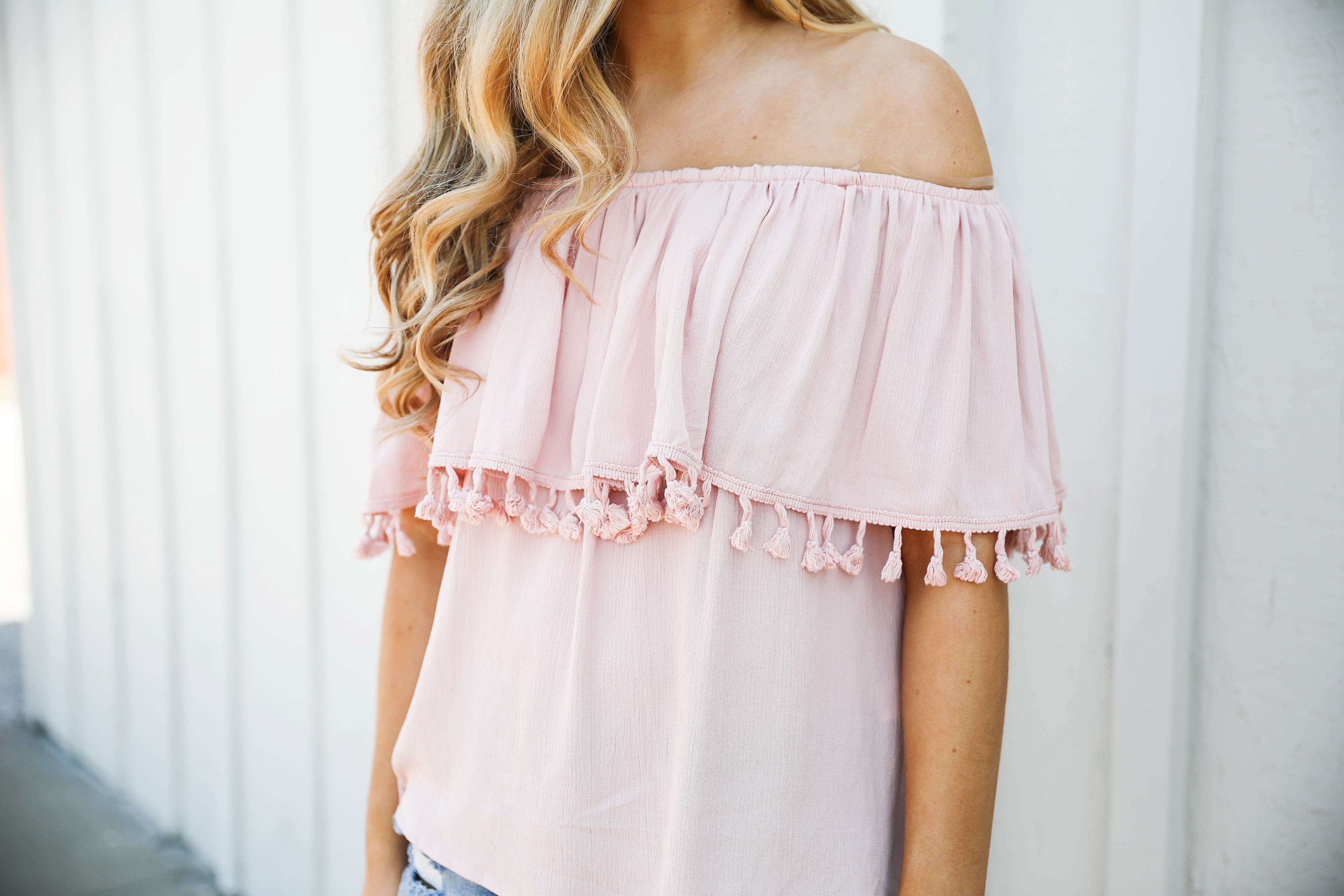 Pink ruffle pom pom top with jean shorts. This is the cutest spring outfit ever! I love the ruffle trend! on Daily Dose of Charm by Lauren Lindmark dailydoseofcharm.com