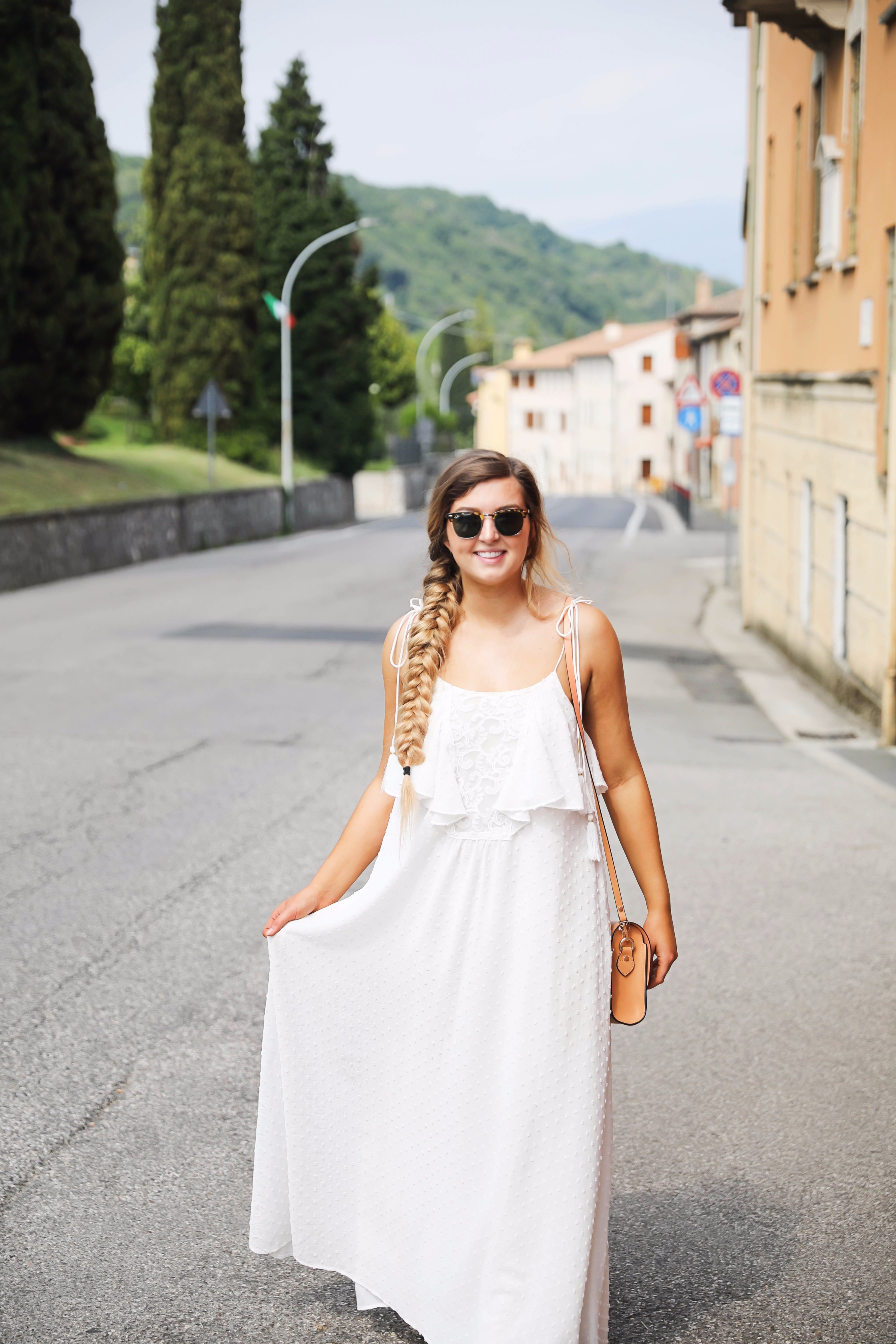 White flowy maxi dress with long fishtail braid in Paderno del Grappa, Italy by fashion blogger Lauren Lindmark daily dose of charm dailydoseofcharm.com