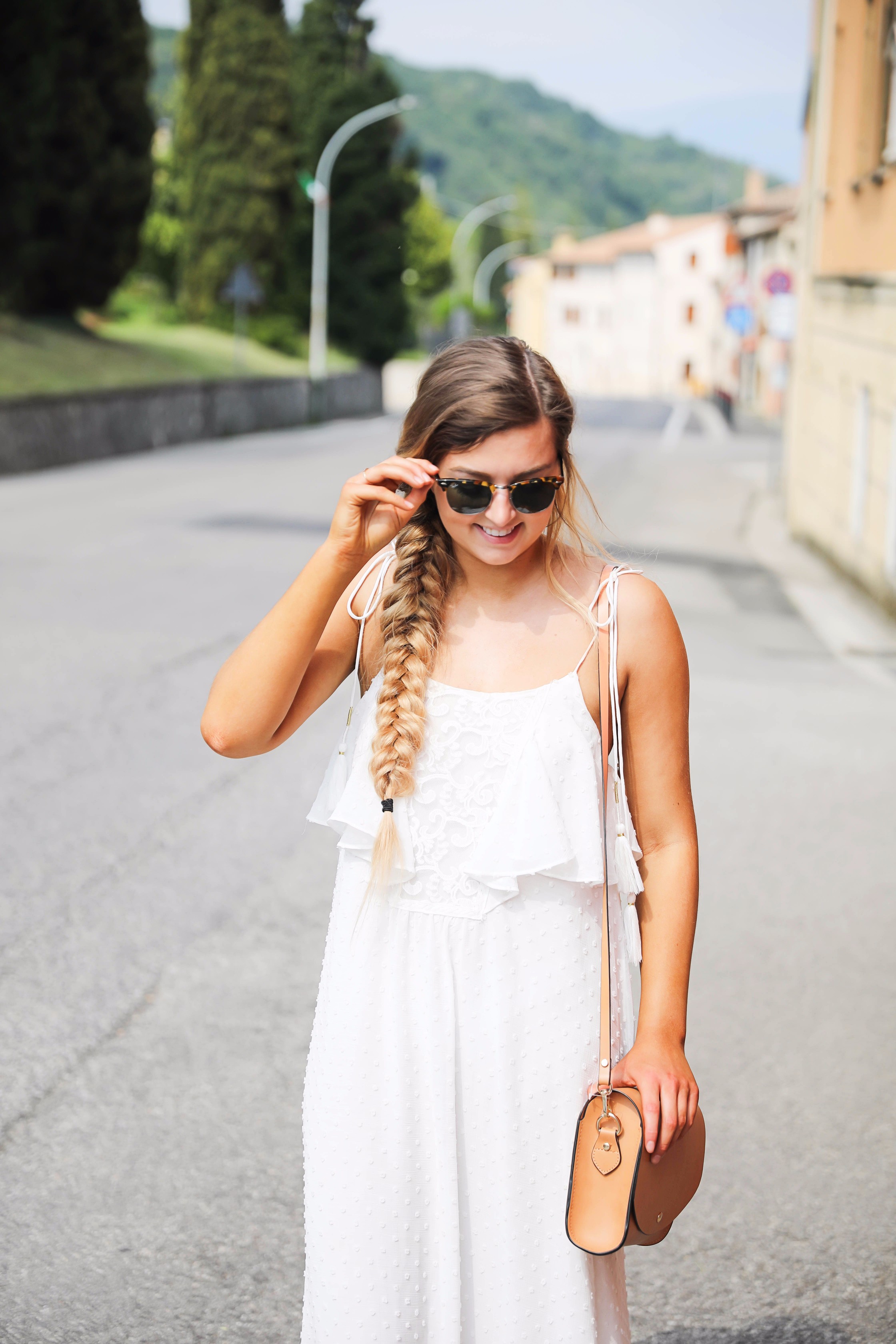 White flowy maxi dress with long fishtail braid in Paderno del Grappa, Italy by fashion blogger Lauren Lindmark daily dose of charm dailydoseofcharm.com