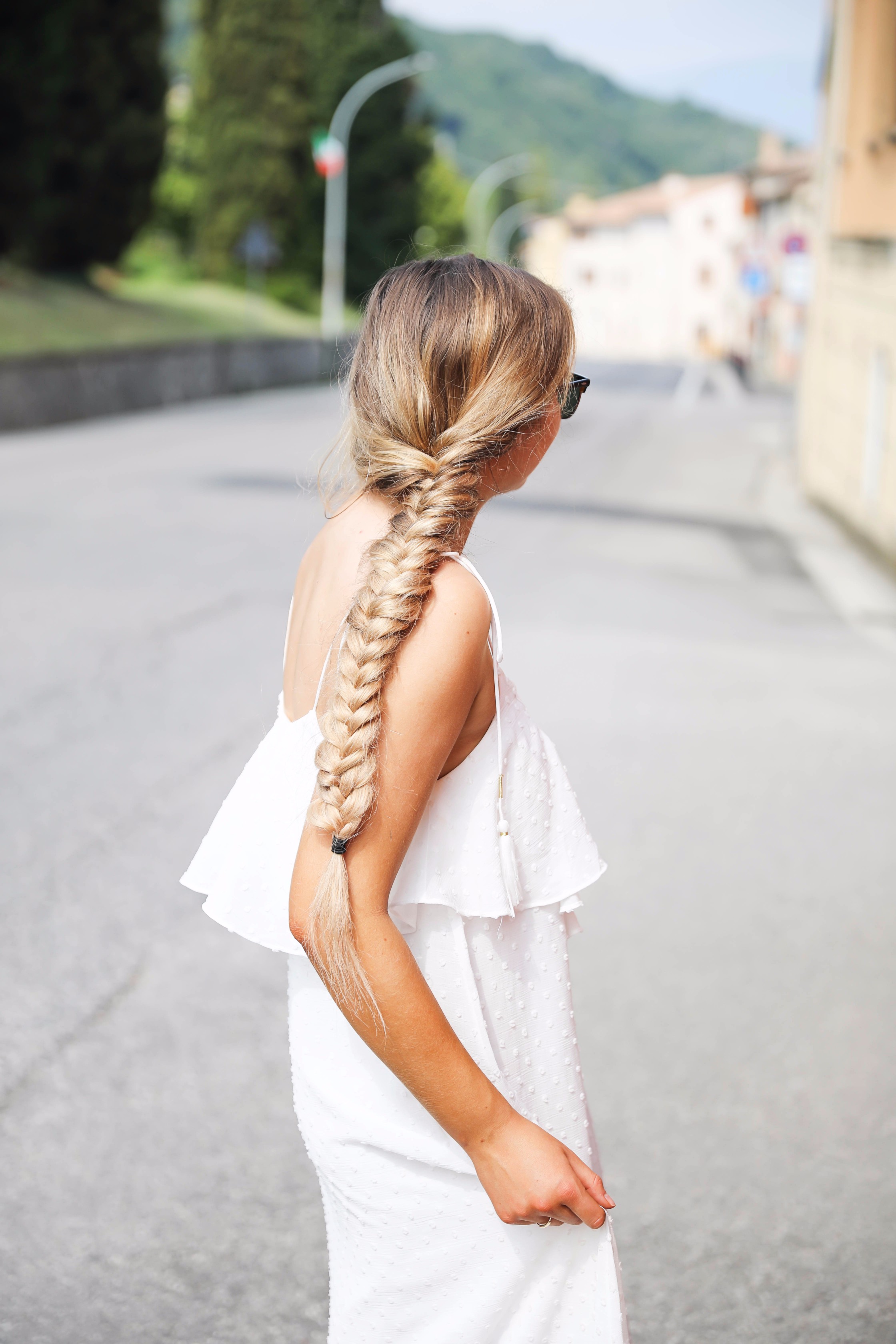 White flowy maxi dress with long fishtail braid in Paderno del Grappa, Italy by fashion blogger Lauren Lindmark daily dose of charm dailydoseofcharm.com