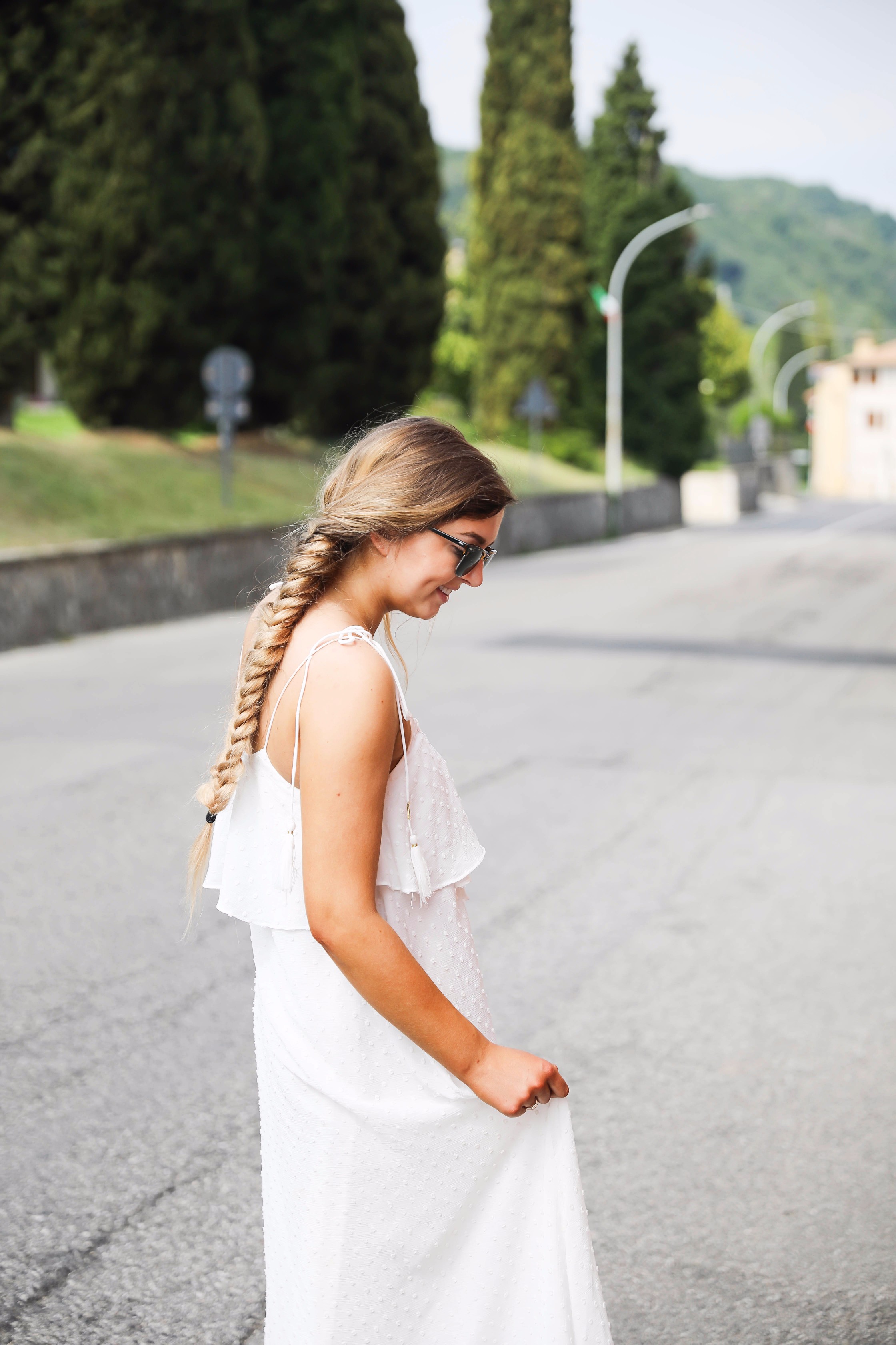 White flowy maxi dress with long fishtail braid in Paderno del Grappa, Italy by fashion blogger Lauren Lindmark daily dose of charm dailydoseofcharm.com