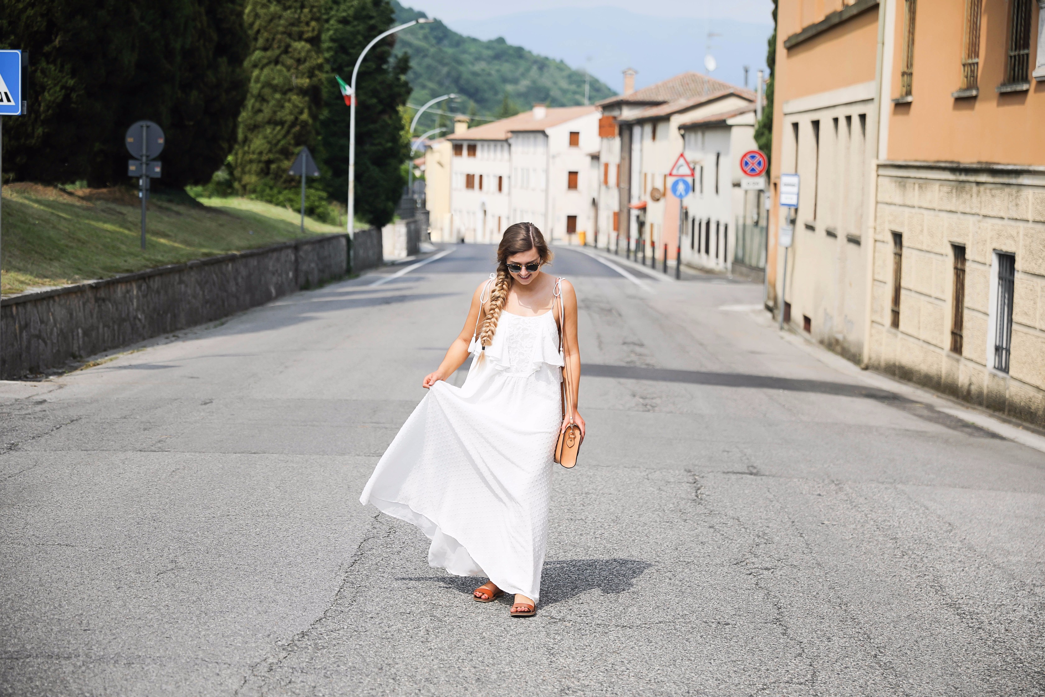 White flowy maxi dress with long fishtail braid in Paderno del Grappa, Italy by fashion blogger Lauren Lindmark daily dose of charm dailydoseofcharm.com