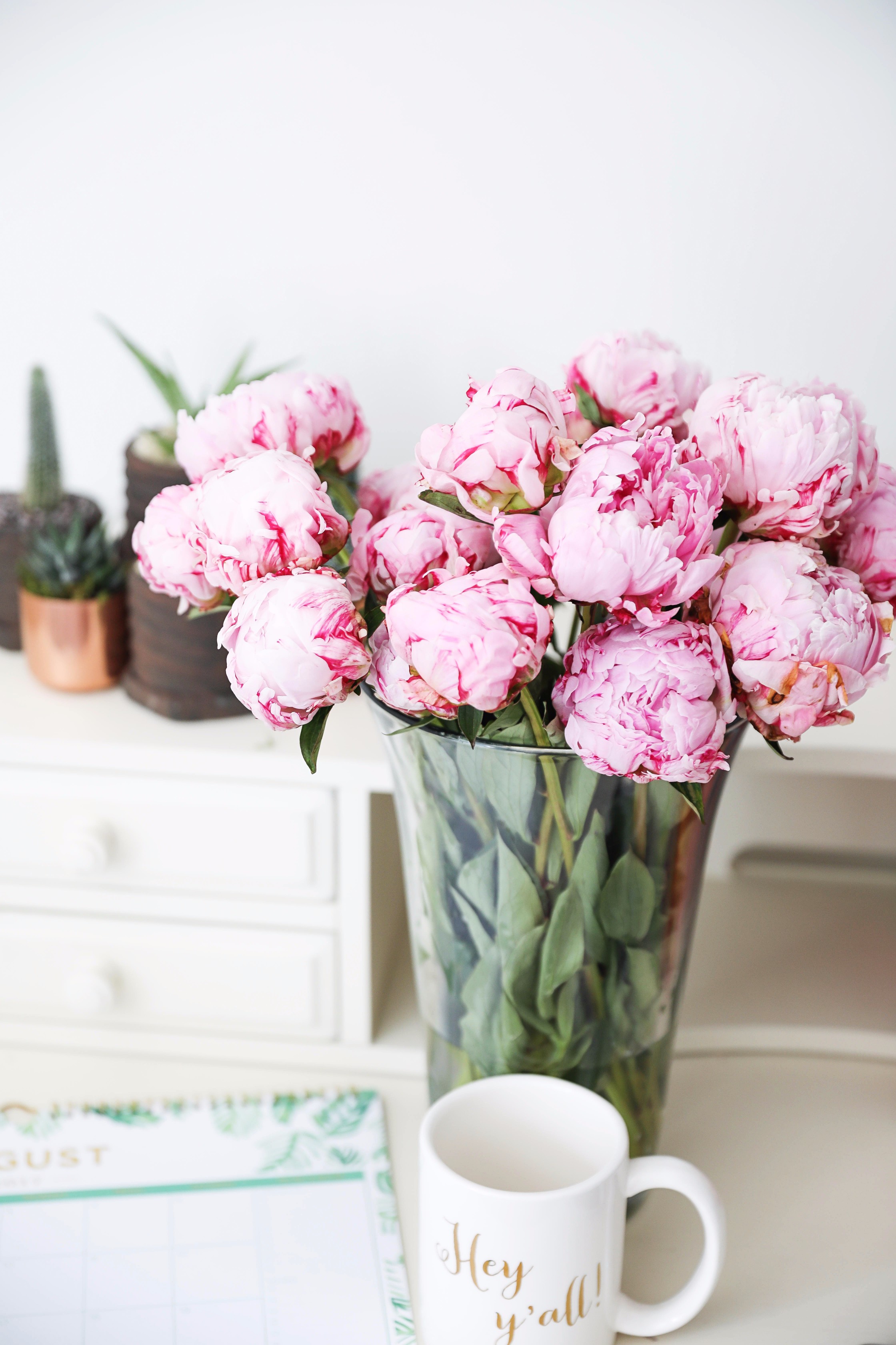 Pink peonies, cactus and succulents, and palm leaf calendar on June favorites by fashion and lifestyle blogger lauren lindmark on daily dose of charm
