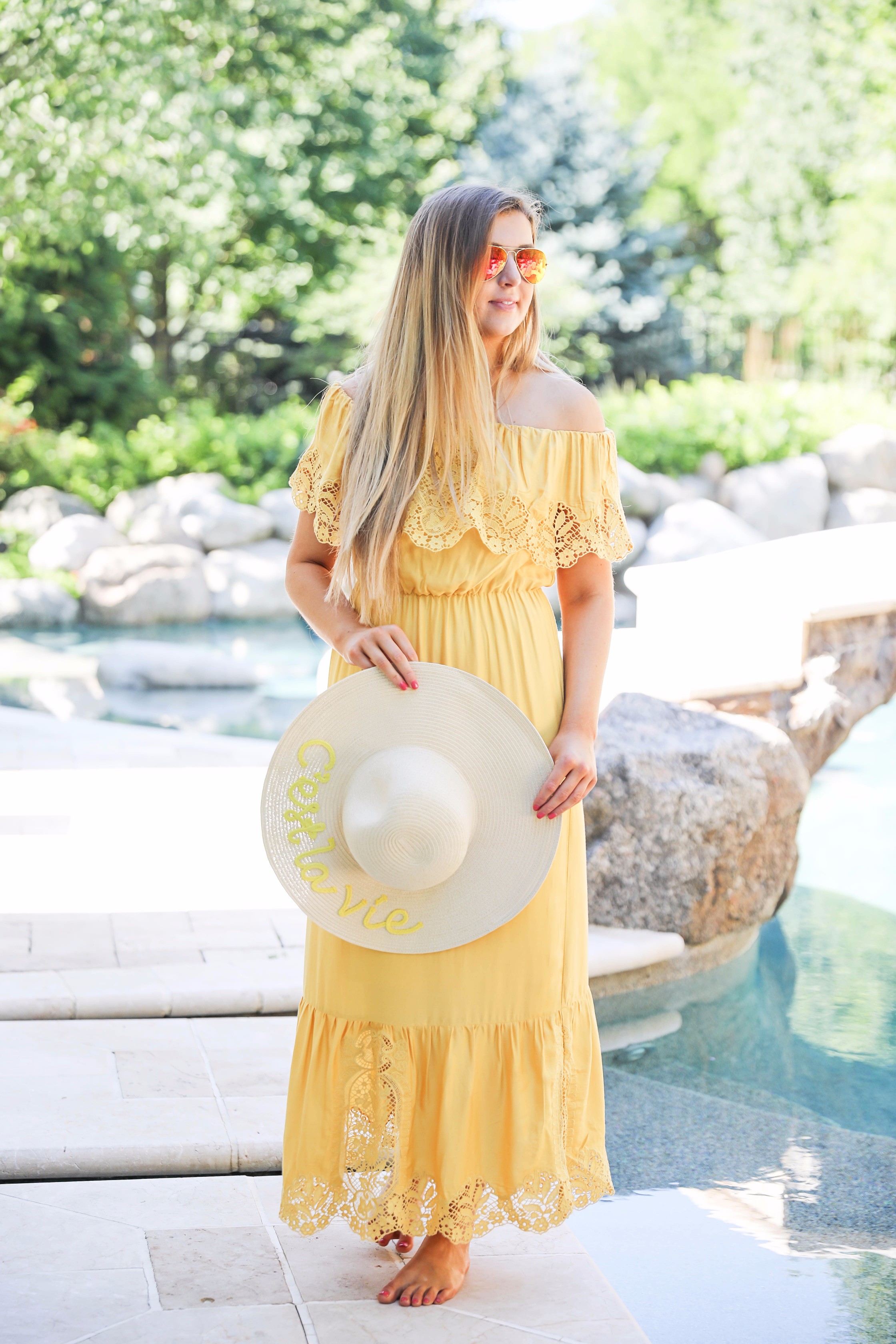 Yellow midi maxi dress poolside with cest la vie quote sun hat on fashion blog daily dose of charm by lauren lindmark