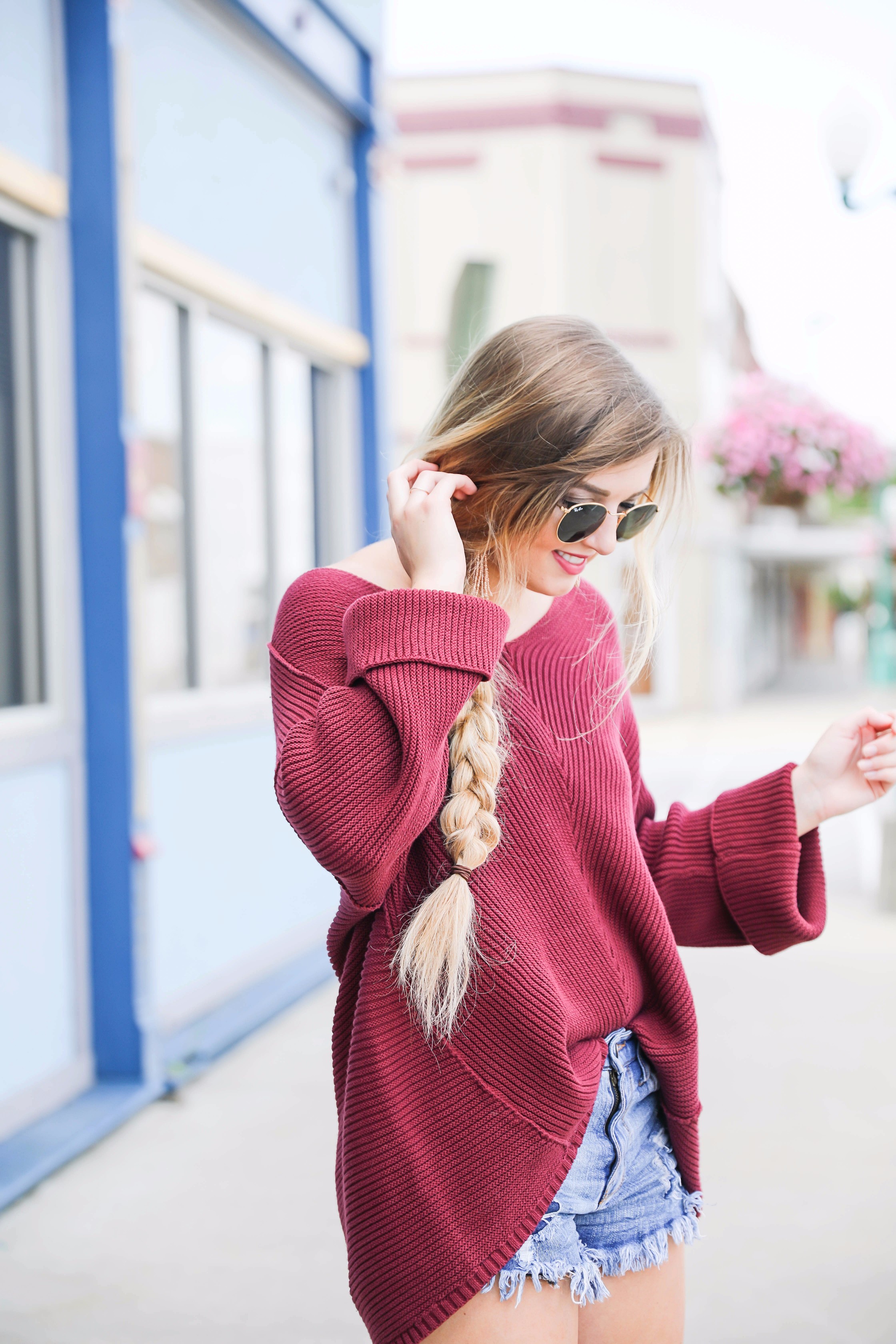 Cutest slouchy burgundy sweater worn with ripped denim shorts. This sweater is from the 2017 nordstrom anniversary sale! By fashion blogger lauren lindmark on daily dose of charm dailydoseofcharm.com