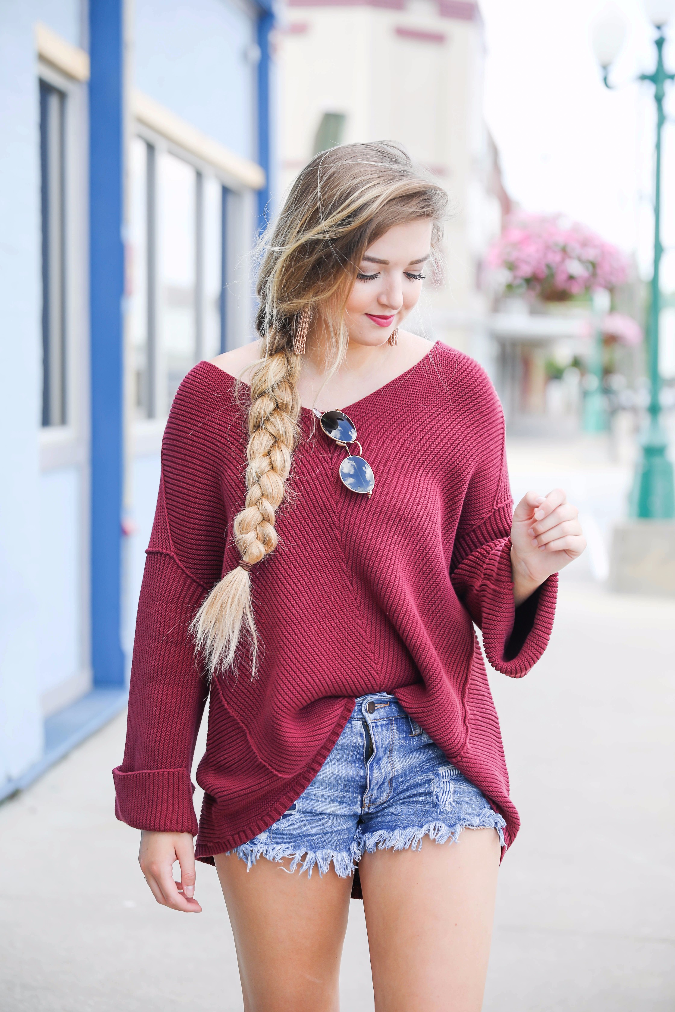 Cutest slouchy burgundy sweater worn with ripped denim shorts. This sweater is from the 2017 nordstrom anniversary sale! By fashion blogger lauren lindmark on daily dose of charm dailydoseofcharm.com