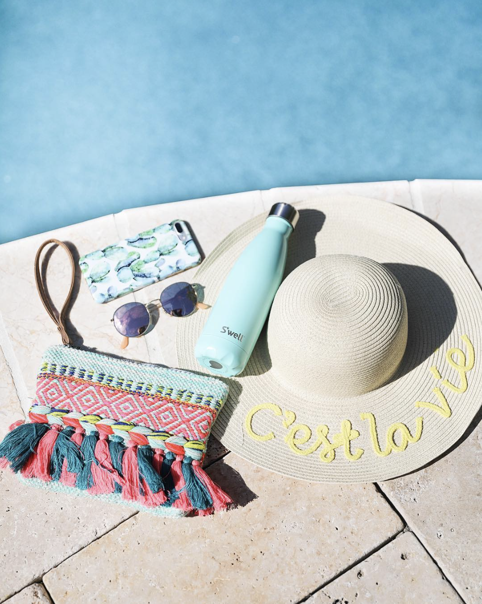 Colorful tassel clutch, S'Well bottle, cactus phone case, sunglasses, and c'est la vie sun hat on June Instagram Roundup 2017 on fashion Instagram @dailydoseofcharm by fashion blogger daily dose of charm AKA lauren lindmark