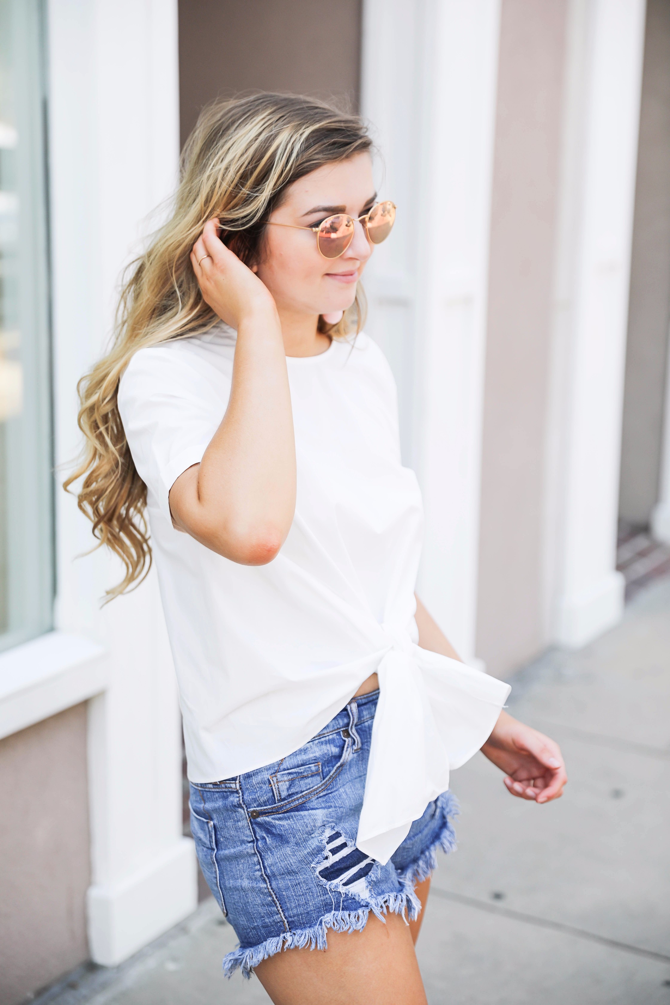 White tied bow tee makes a classic white shirt look so much cuter! I paired it with my favorite pink same edelman bow sandal and bauble bar earrings. by fashion blogger lauren lindmark on daily dose of charm