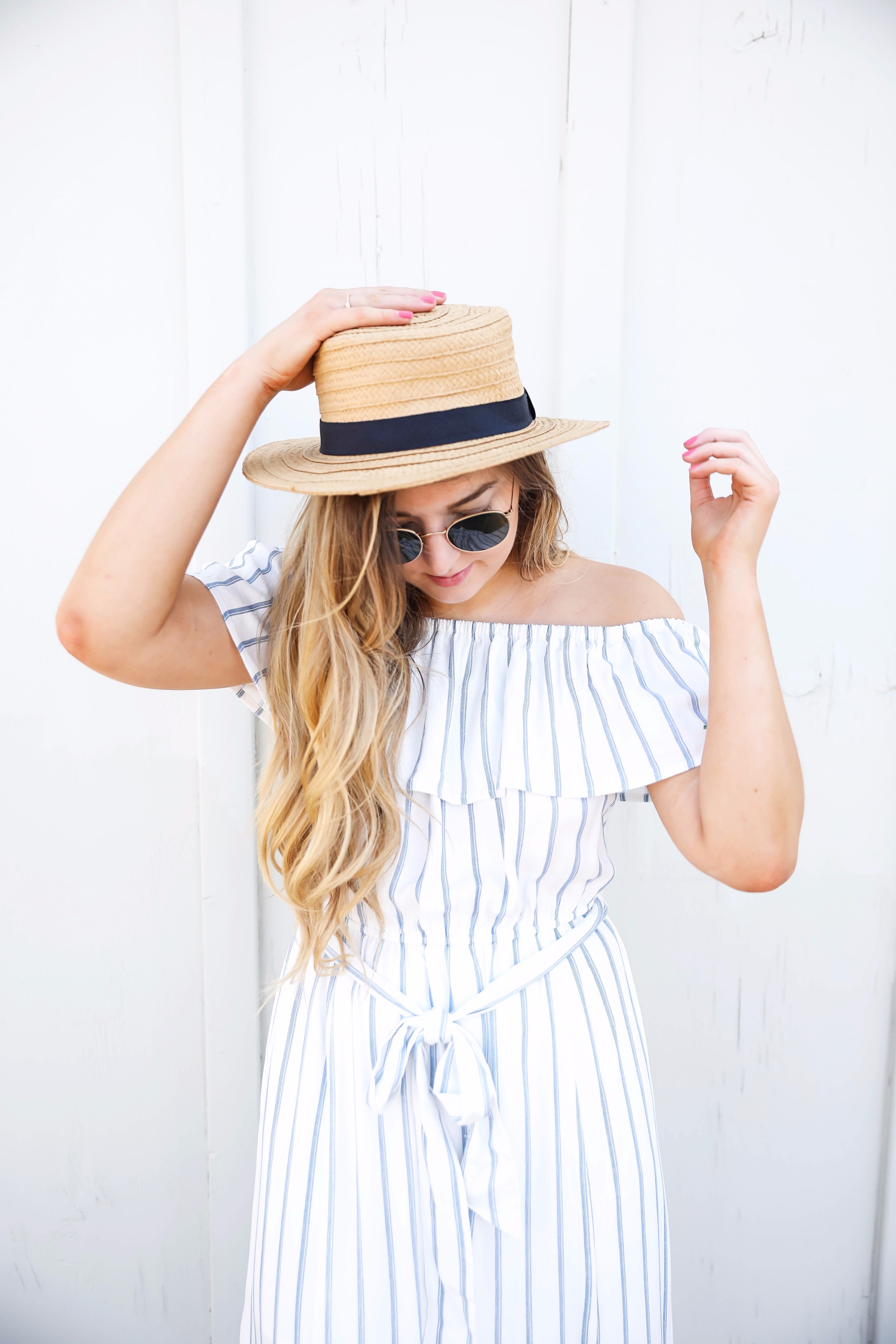 Navy and white striped off the shoulder boardwalk dress! I paired it with a cute boat hat and clubmasters! By fashion blogger daily dose of charm lauren lindmark