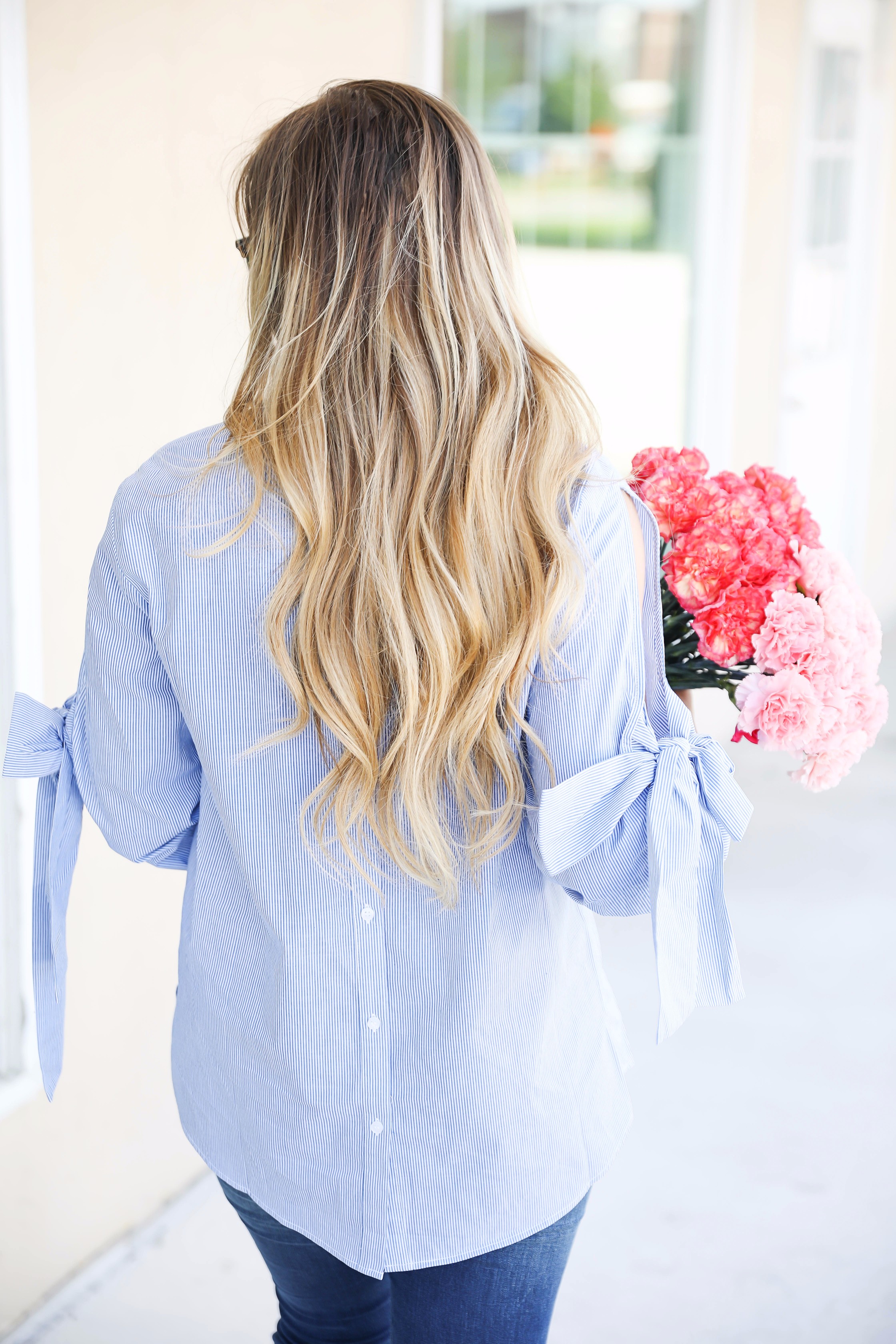 Seersucker bow sleeve cold shoulder top and tape in extensions! The prettiest flowers with the cutest outfit! on fashion blog daily dose of charm by lauren lindmark