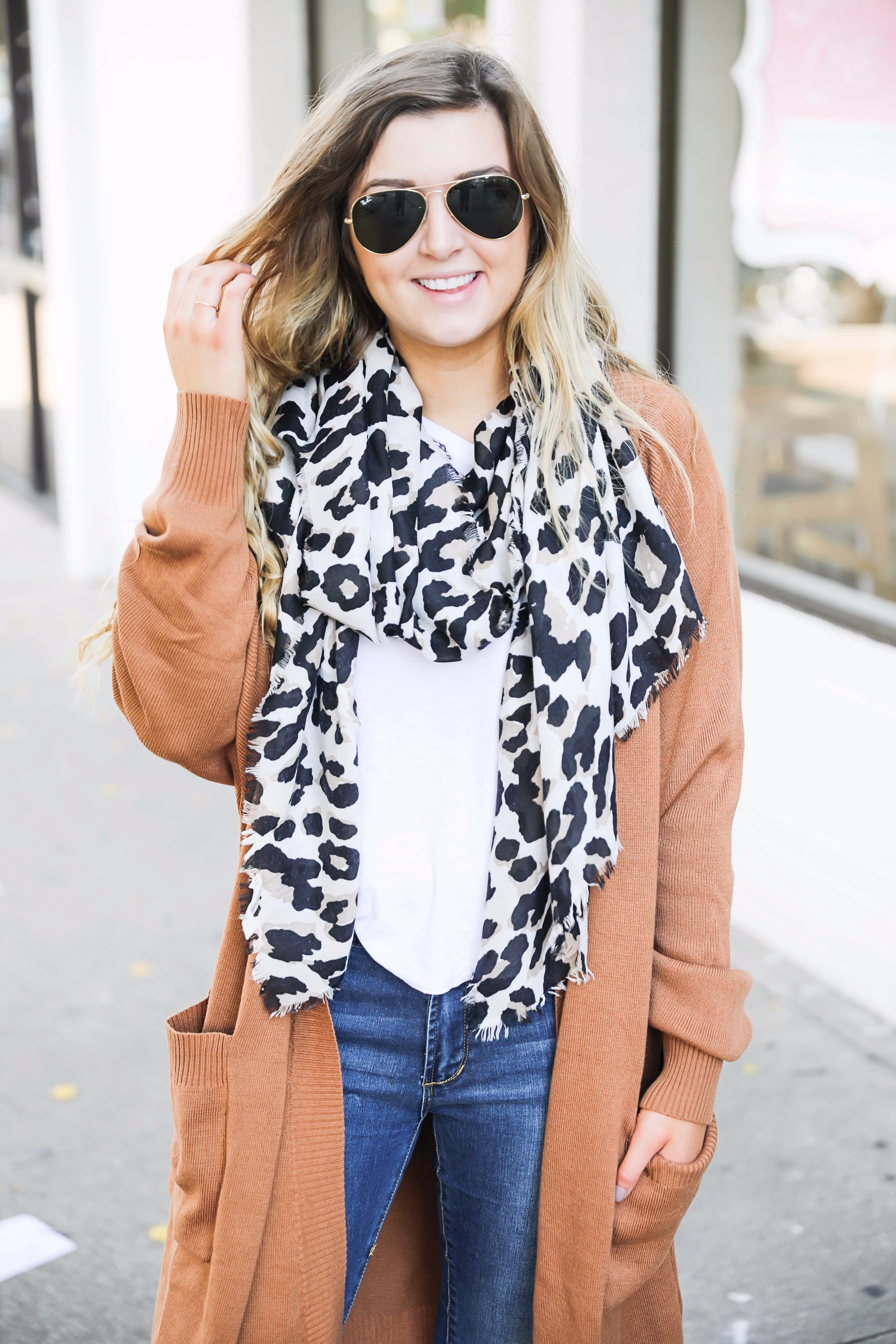 Adorable leopard scarf paired with a burnt orange cardigan! This is the fall outfit you need in your closet! Leopard is so in right now and this scarf is a necessity! The burnt orange cardigan in a staple! Find the details on fashion blog daily dose of charm by lauren lindmark