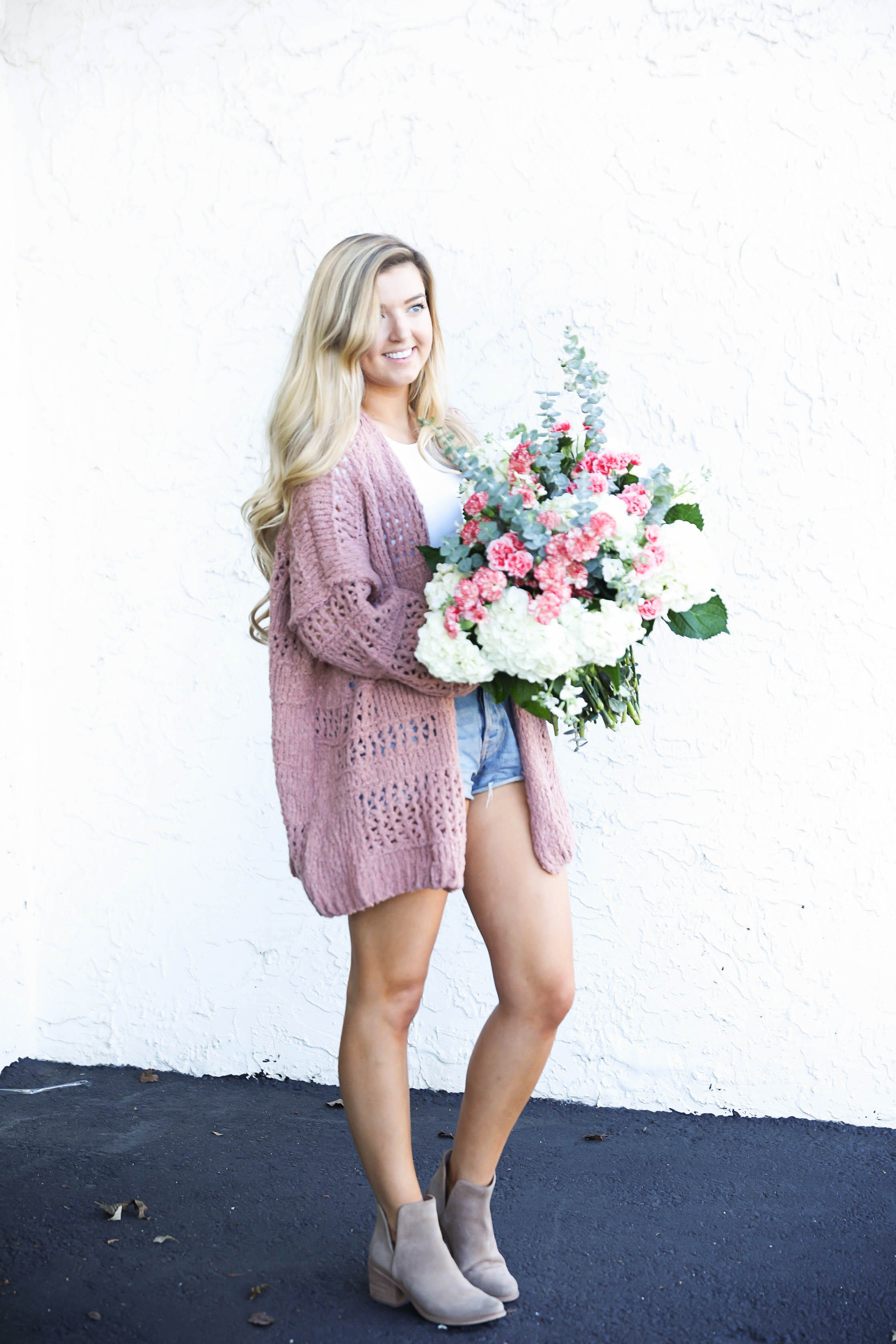 Free people cardigan and fresh flowers with long curly hair by fashion blog daily dose of charm lauren lindmark