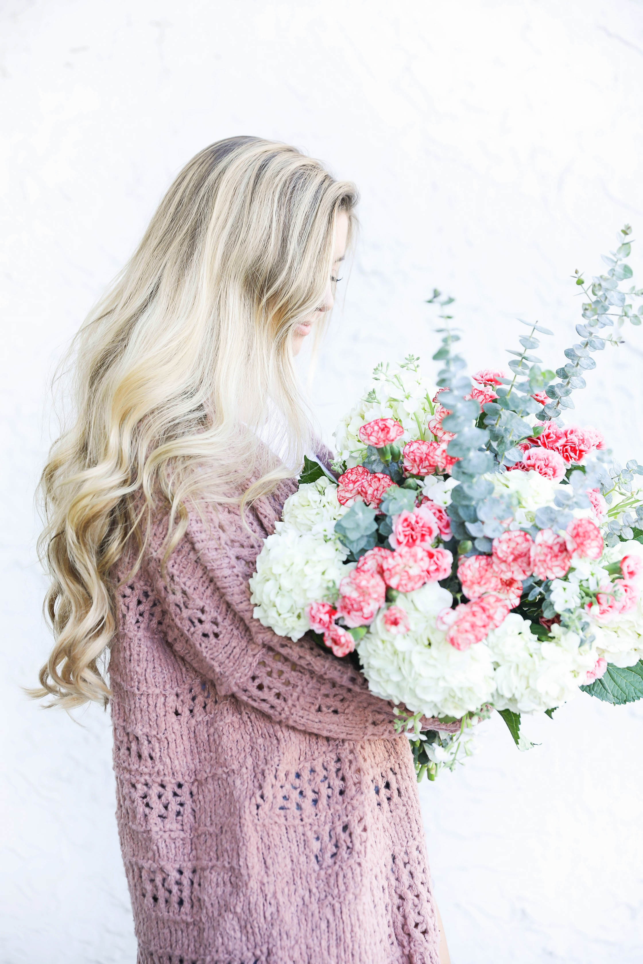 Free people cardigan and fresh flowers with long curly hair by fashion blog daily dose of charm lauren lindmark