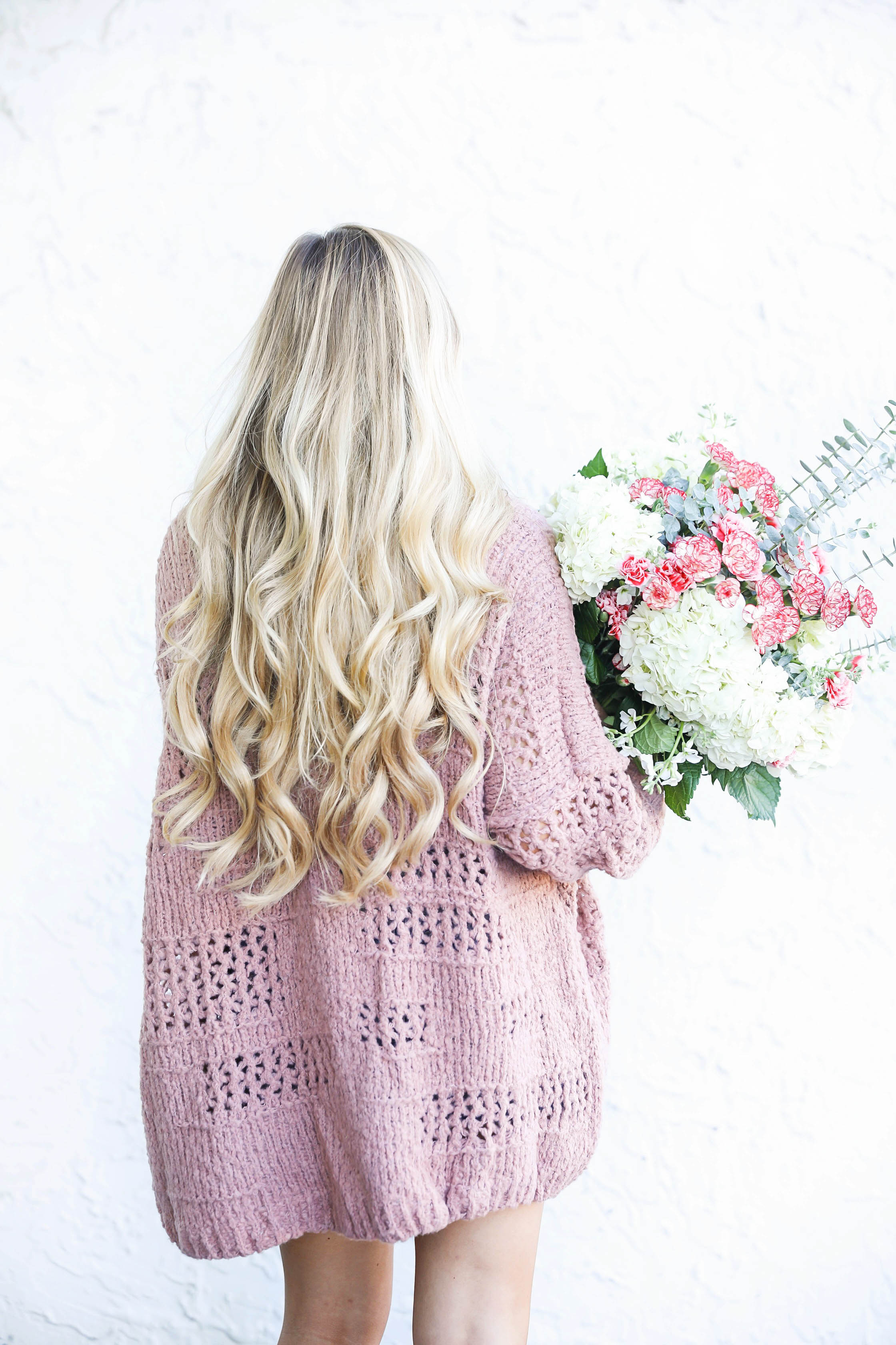 Free people cardigan and fresh flowers with long curly hair by fashion blog daily dose of charm lauren lindmark