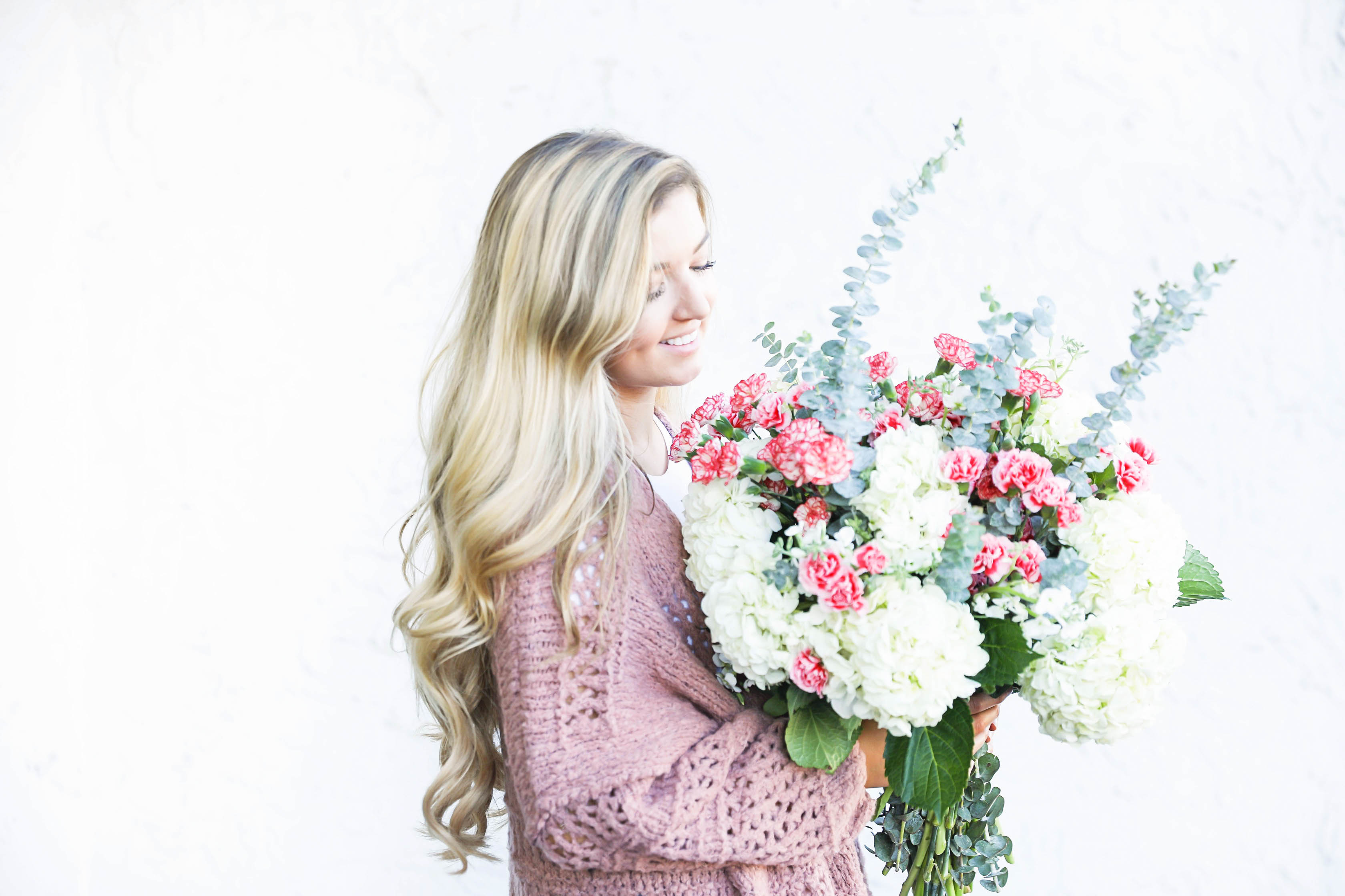 Free people cardigan and fresh flowers with long curly hair by fashion blog daily dose of charm lauren lindmark