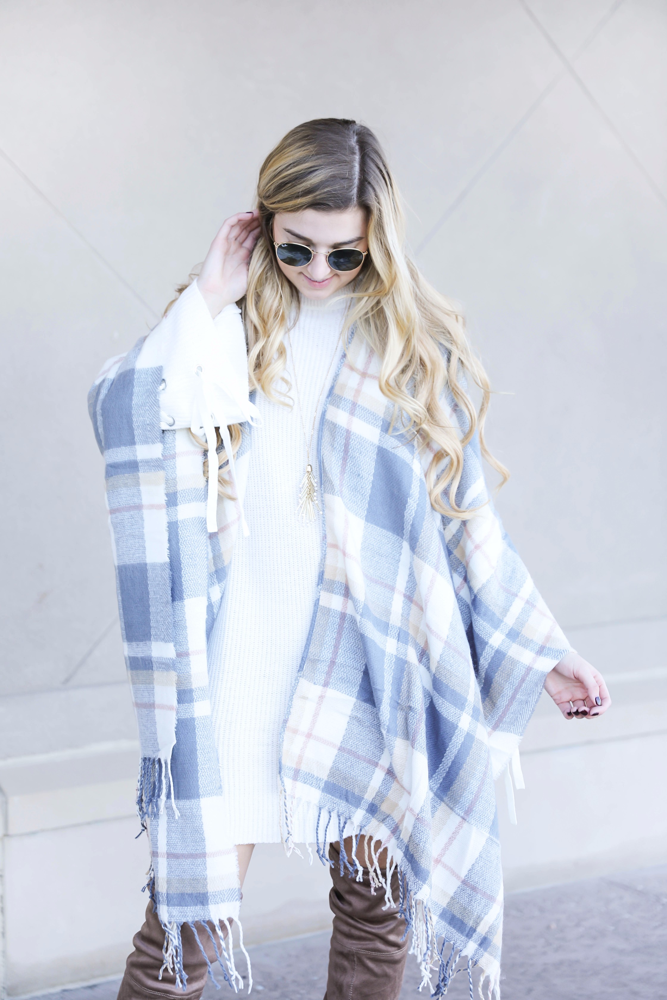 Plaid poncho and cute white sweater dress with tied sleeves! Cutest fall outfit! Check out the details on fashion blog daily dose of charm by lauren lindmark