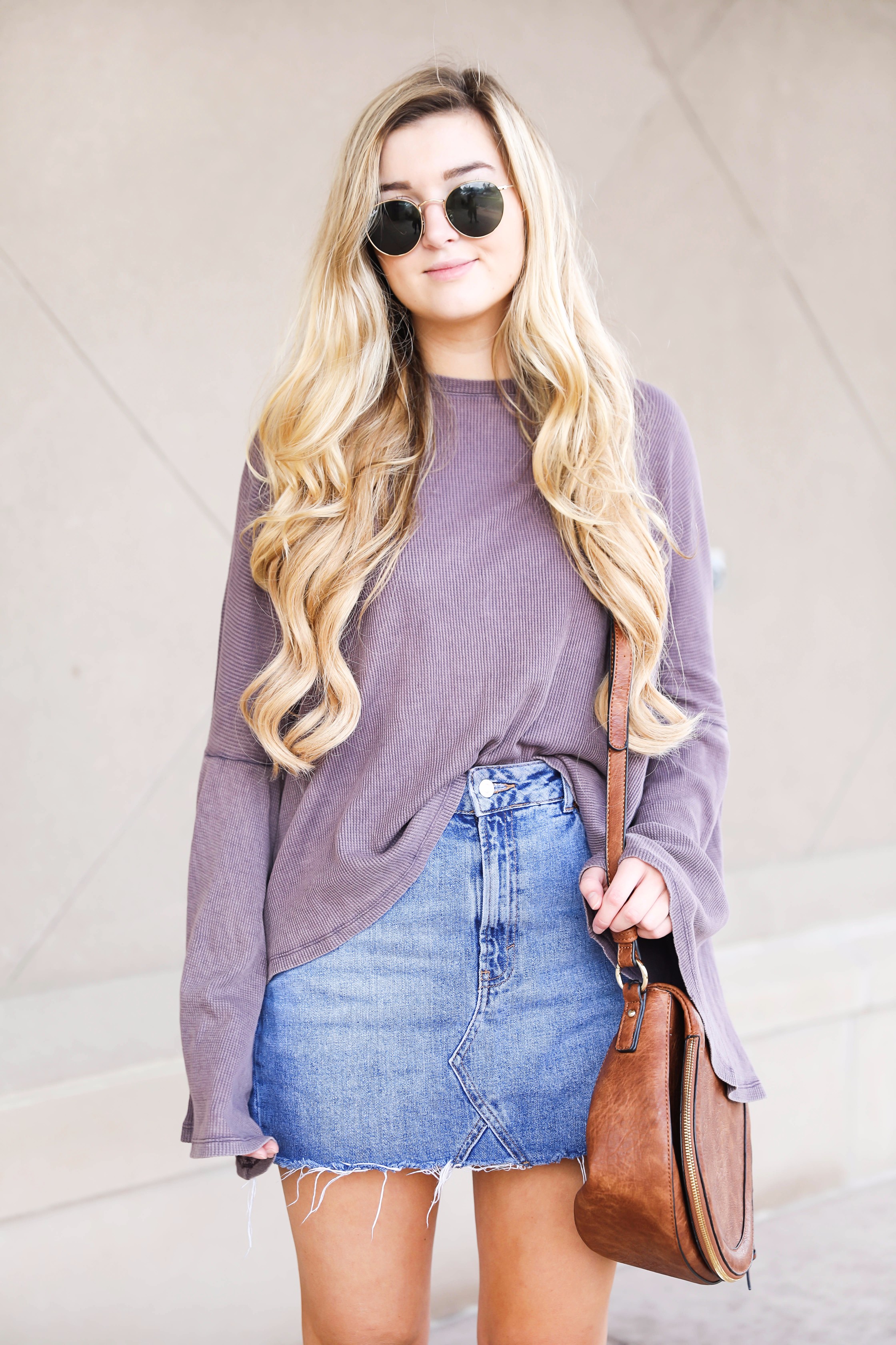 Purple bell sleeve top with jean skirt and saddle bag! Paired with cutout booties! Find the details on fashion blog daily dose of charm by lauren lindmark