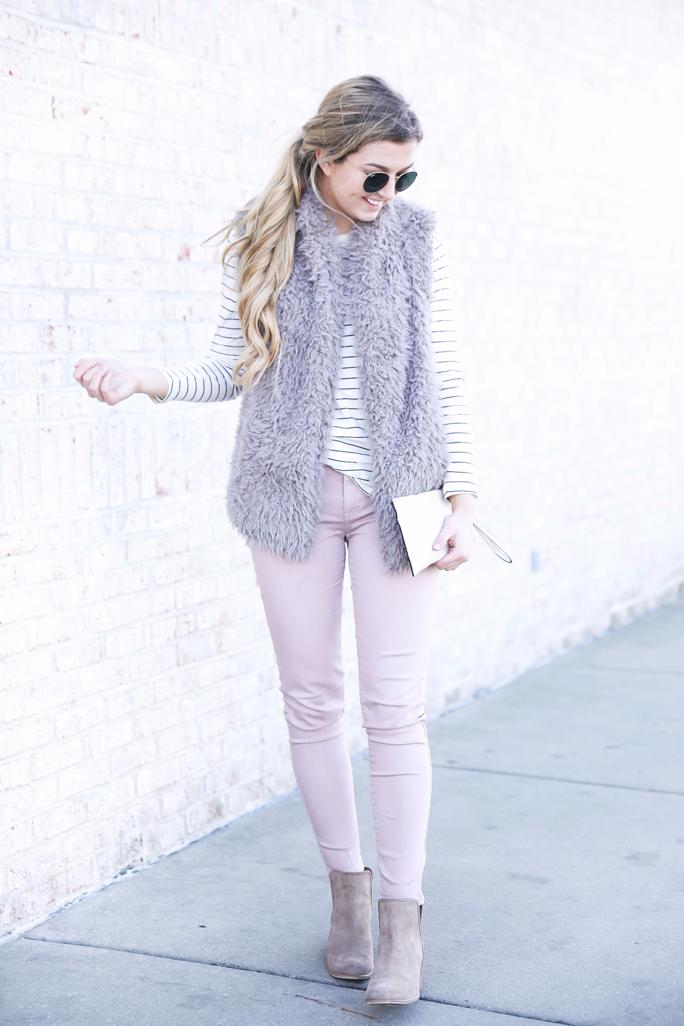 Striped long sleeve t-shirt and faux fur vest with pink pants! Details on fashion blog daily dose of charm by lauren lindmark