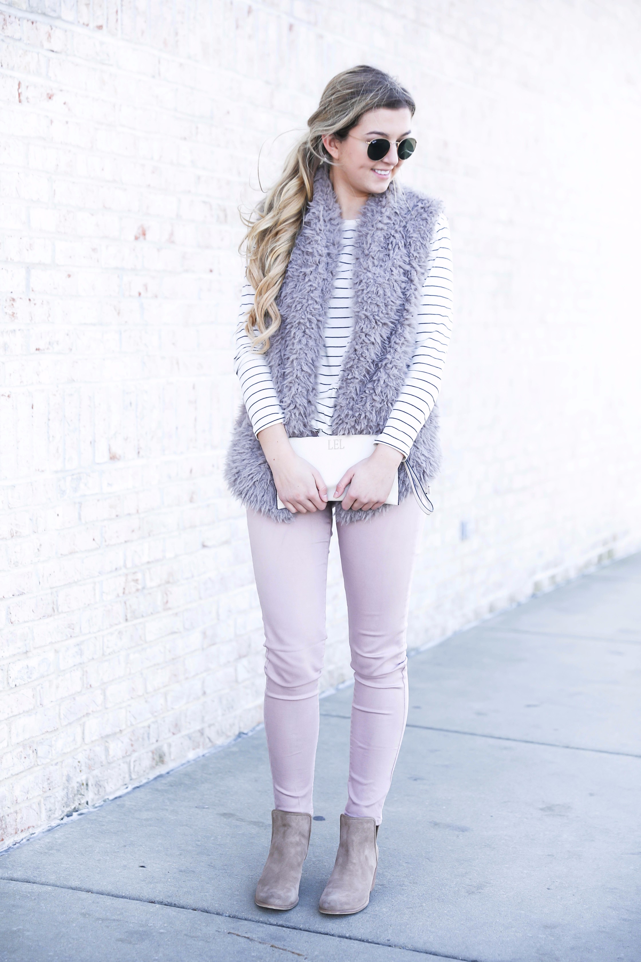 Striped long sleeve t-shirt and faux fur vest with pink pants! Details on fashion blog daily dose of charm by lauren lindmark