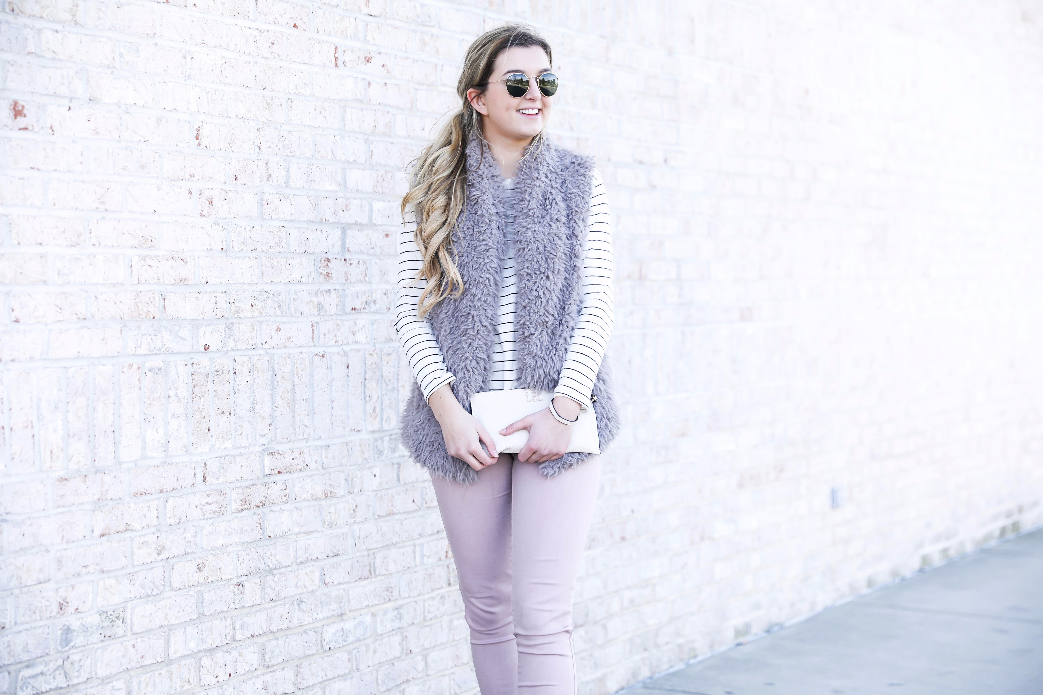 Striped long sleeve t-shirt and faux fur vest with pink pants! Details on fashion blog daily dose of charm by lauren lindmark
