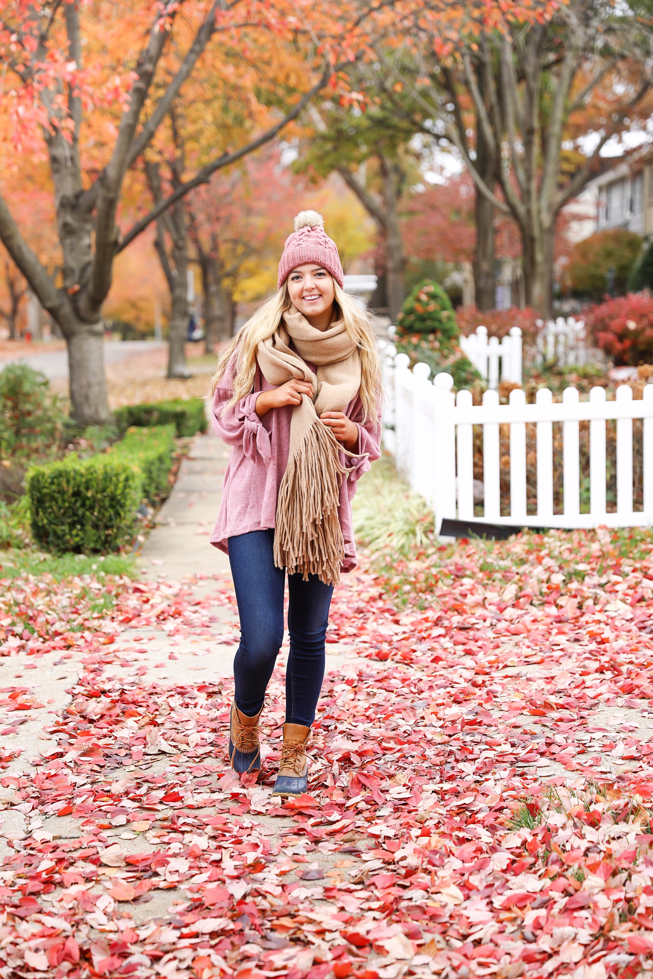 Big fringe scarf with pink tied sweater and pink beanie! Perfect girly fall outfit! Find details on fashion blog daily dose of charm by lauren lindmark