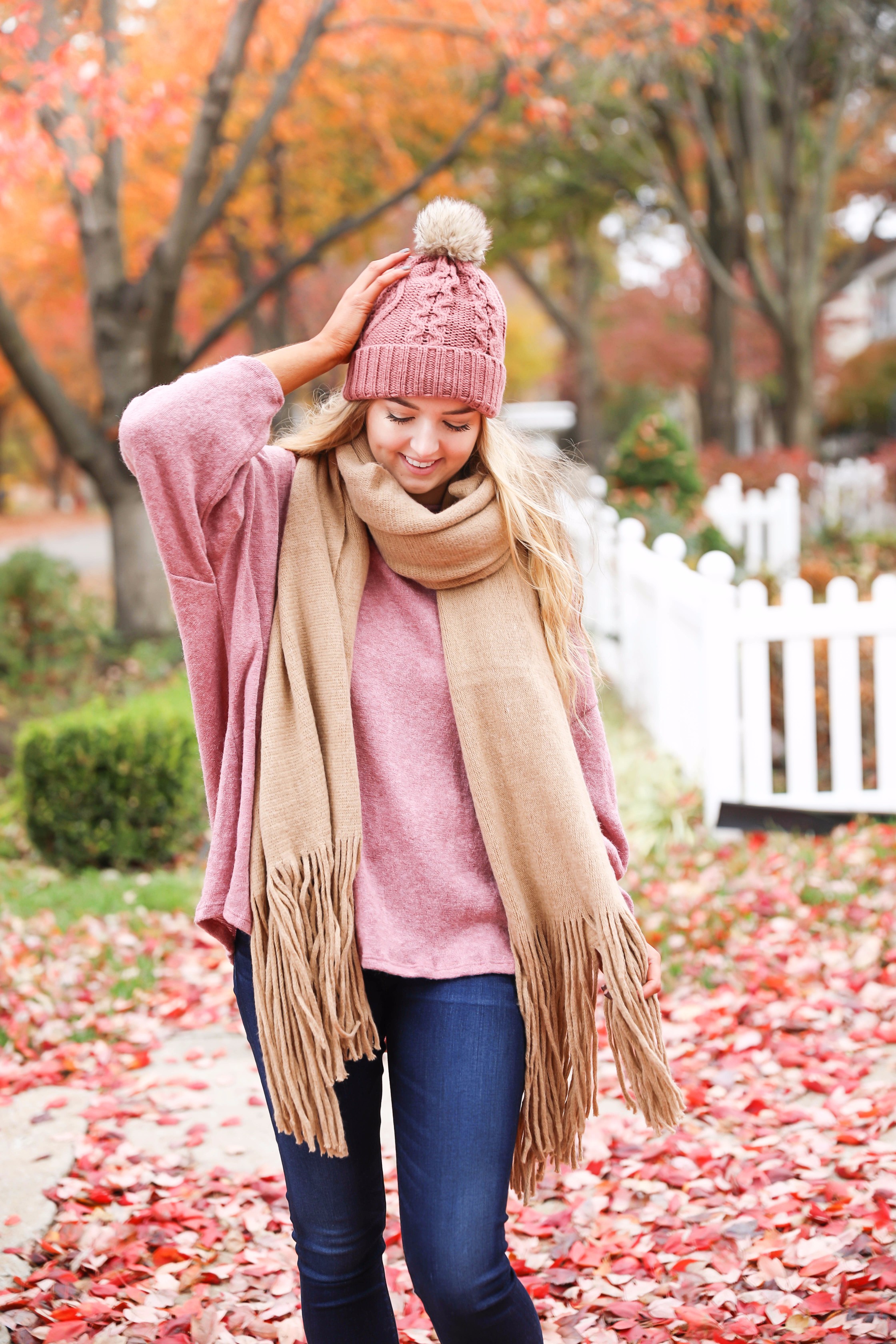 Big fringe scarf with pink tied sweater and pink beanie! Perfect girly fall outfit! Find details on fashion blog daily dose of charm by lauren lindmark