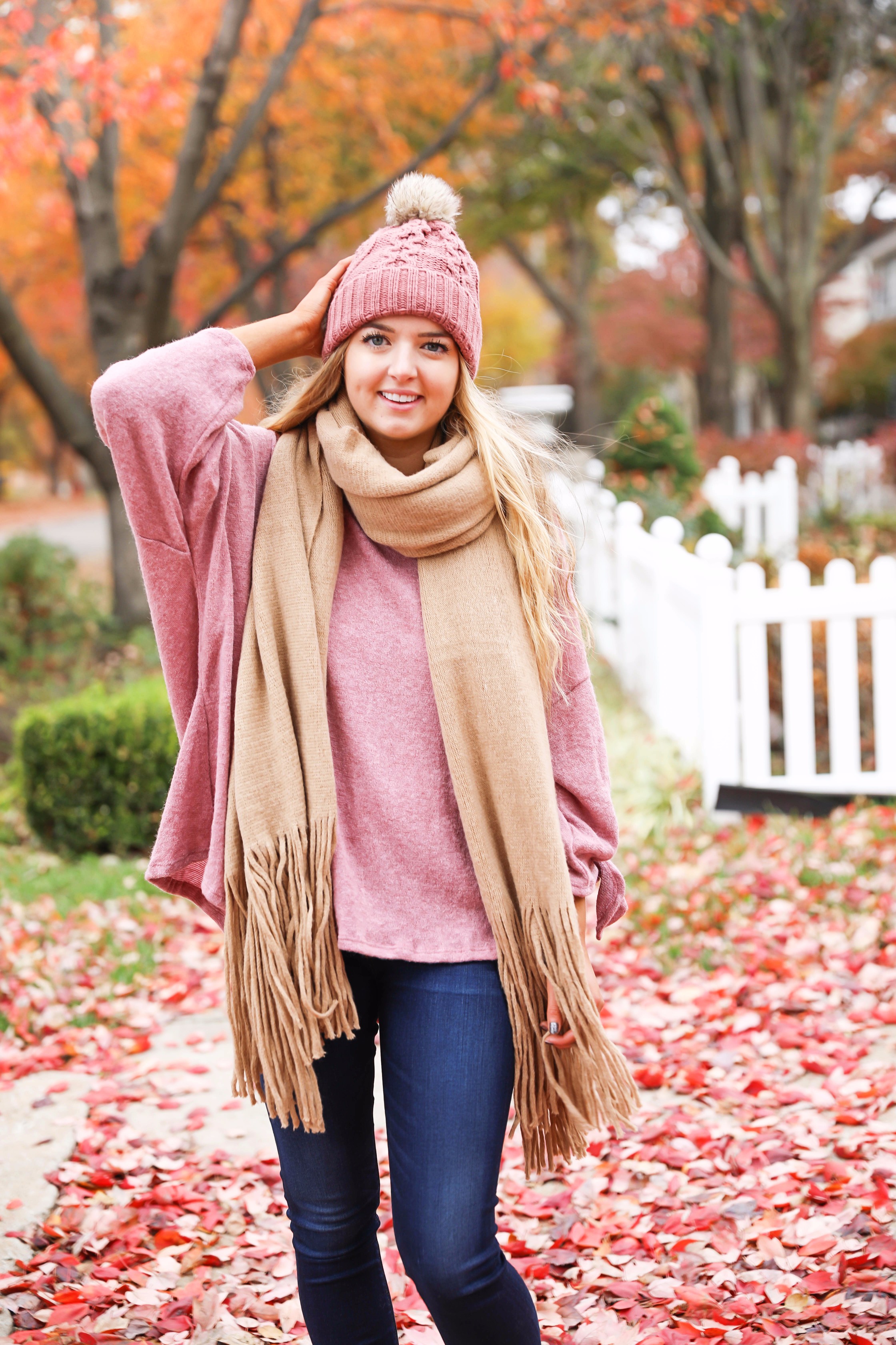 Big fringe scarf with pink tied sweater and pink beanie! Perfect girly fall outfit! Find details on fashion blog daily dose of charm by lauren lindmark
