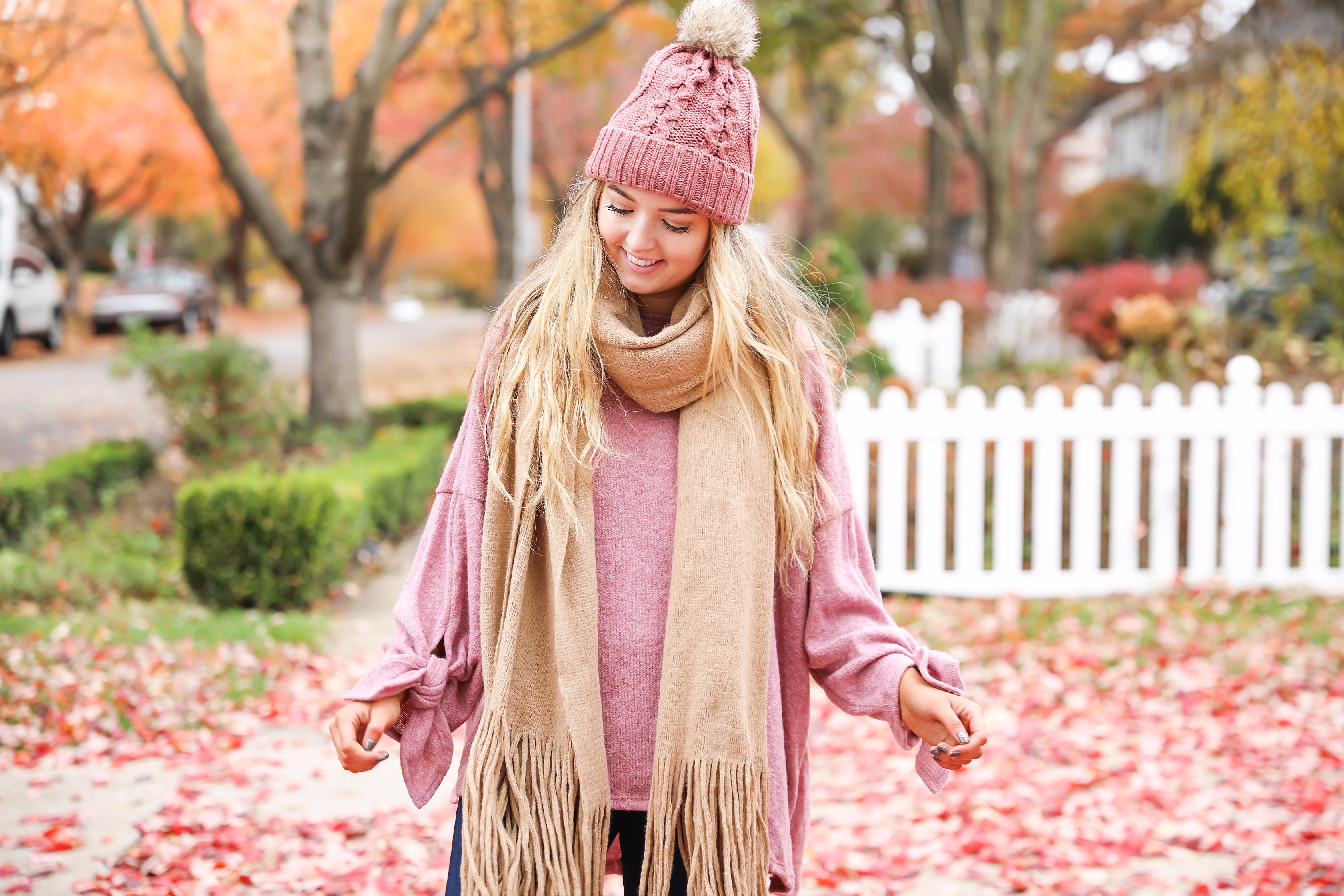 Big fringe scarf with pink tied sweater and pink beanie! Perfect girly fall outfit! Find details on fashion blog daily dose of charm by lauren lindmark