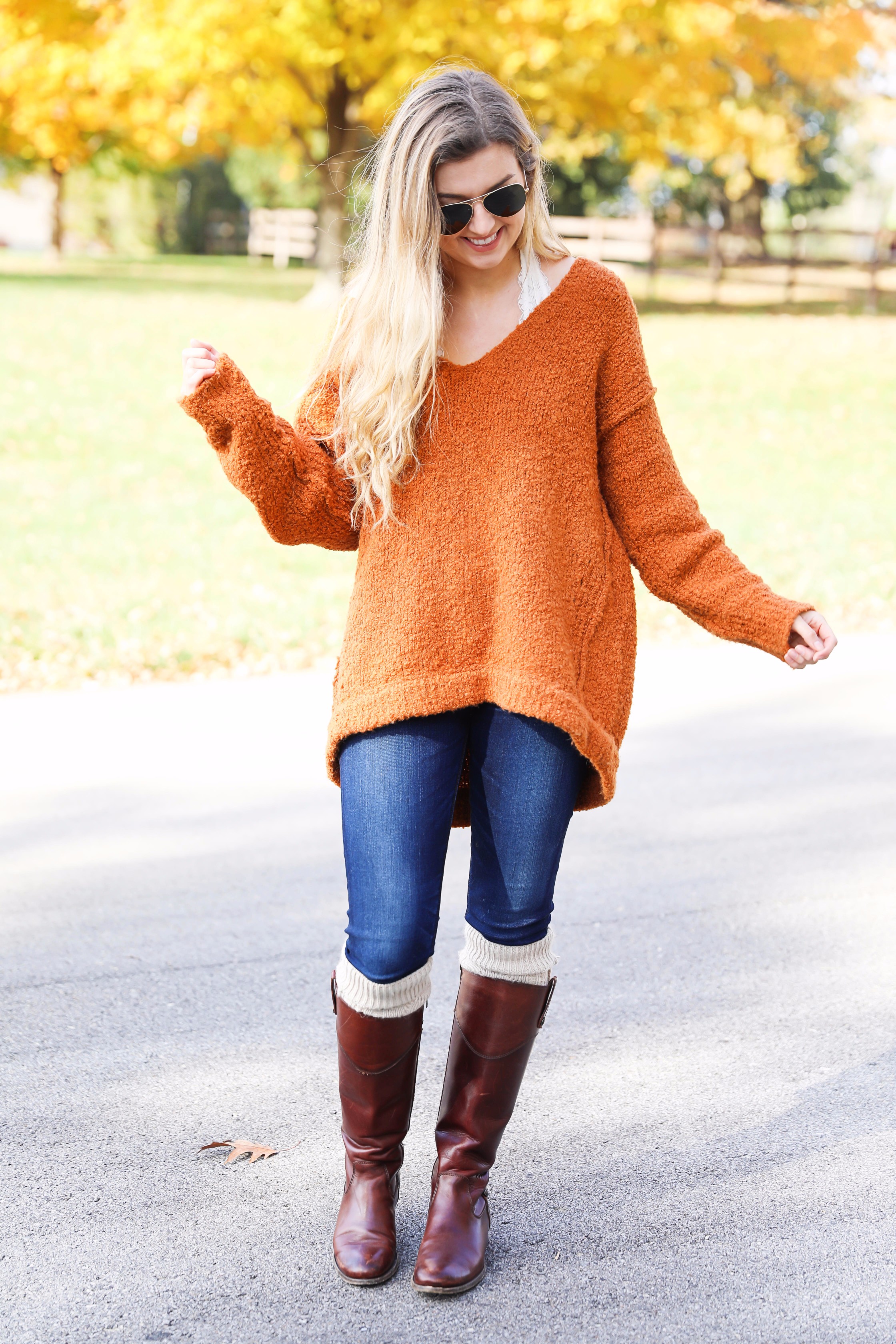 Burnt orange soft free people sweater paired with frye boots and cable knit socks. Fall fashion inspiration! Get details on daily dose of charm fashion blog lauren lindmark