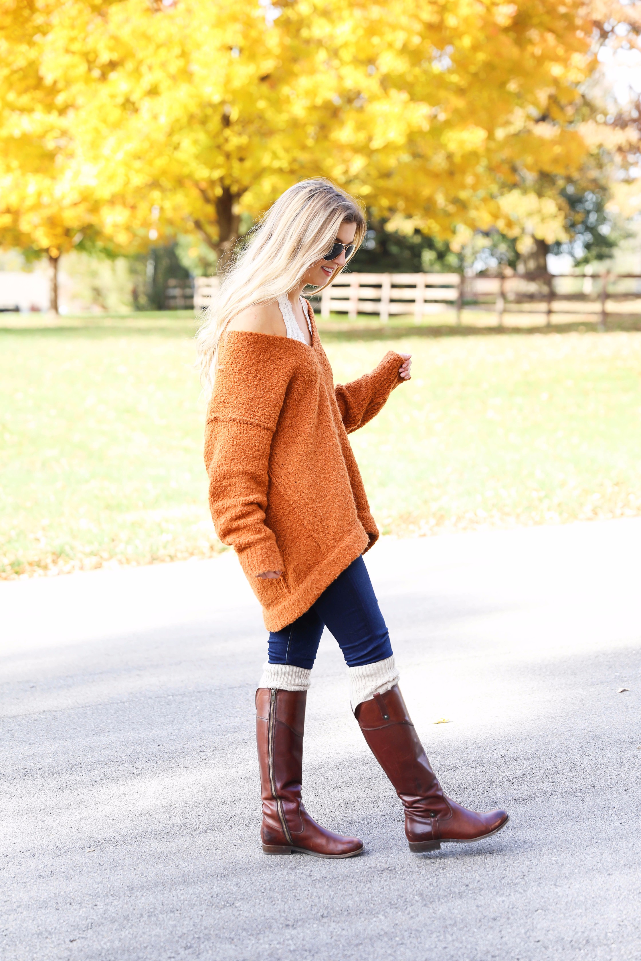 Burnt orange soft free people sweater paired with frye boots and cable knit socks. Fall fashion inspiration! Get details on daily dose of charm fashion blog lauren lindmark